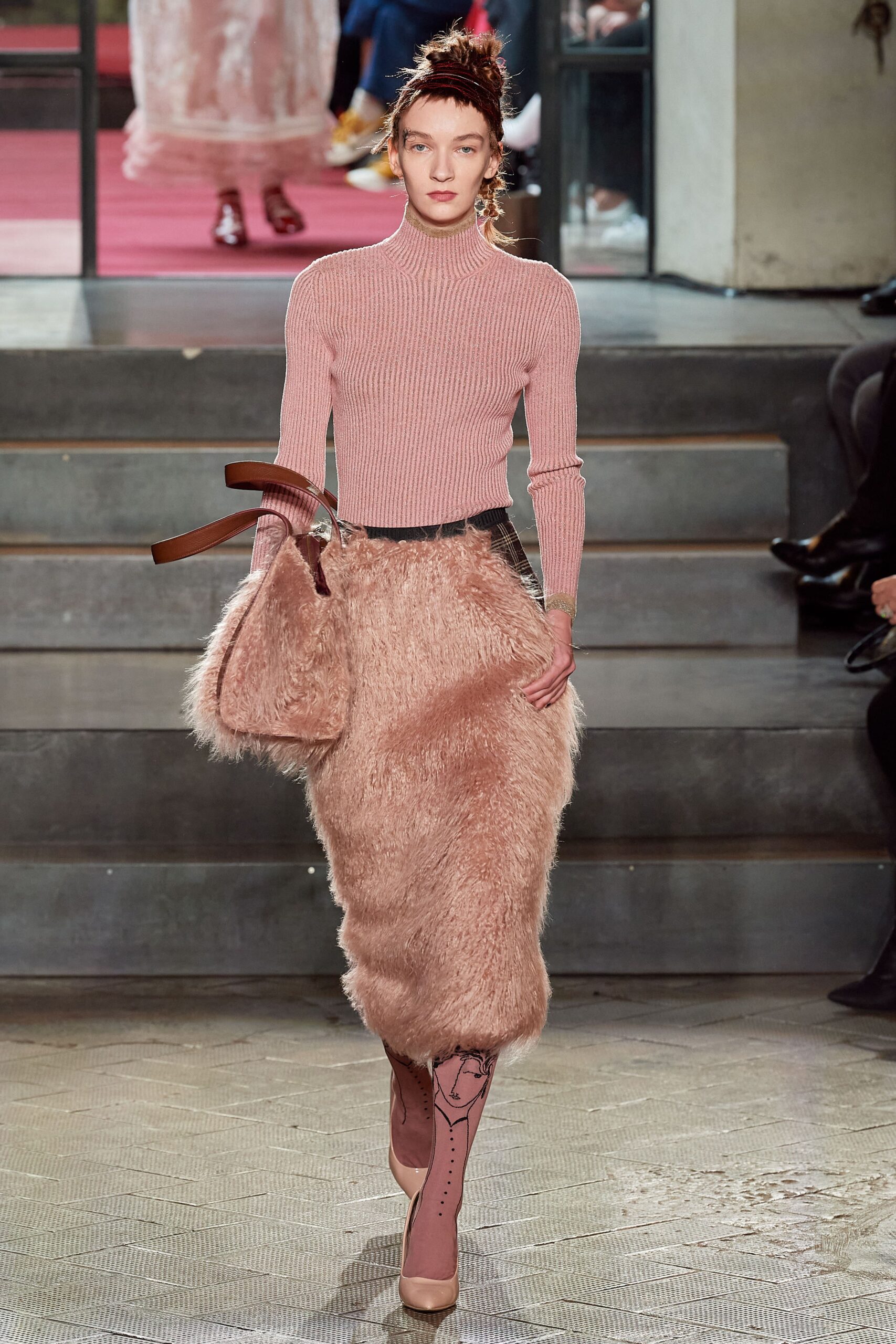 fitted pink wool top and beige fur skirt