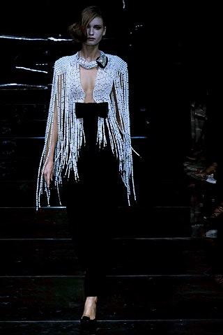 black fitted midi dress with white fringed cape