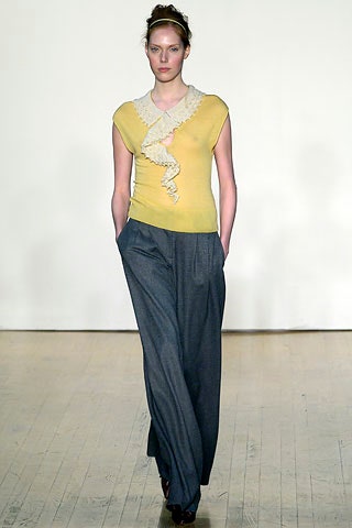 fitted yellow top with ruffles and relaxed gray pants