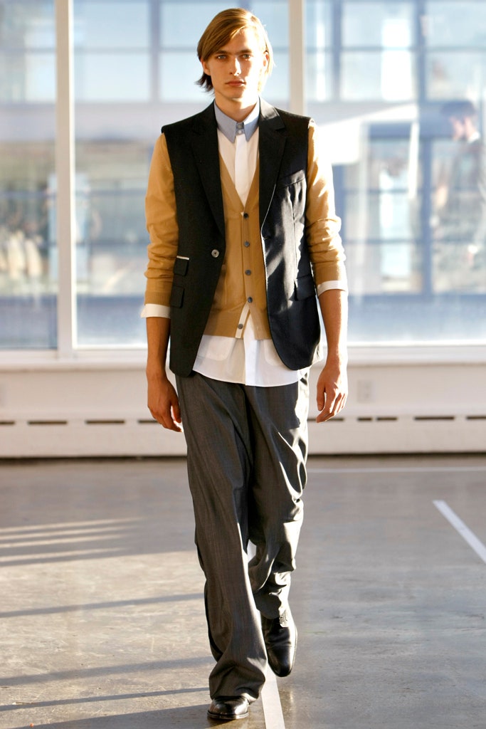 black blazer beige vest white shirt gray pants