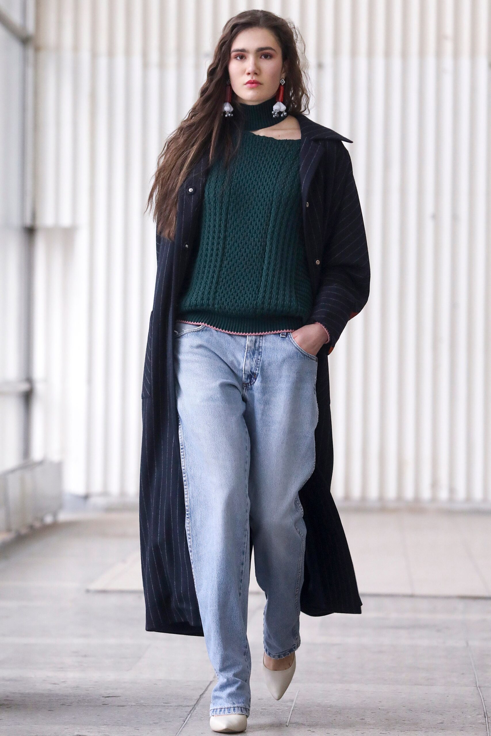 black coat green sweater blue jeans