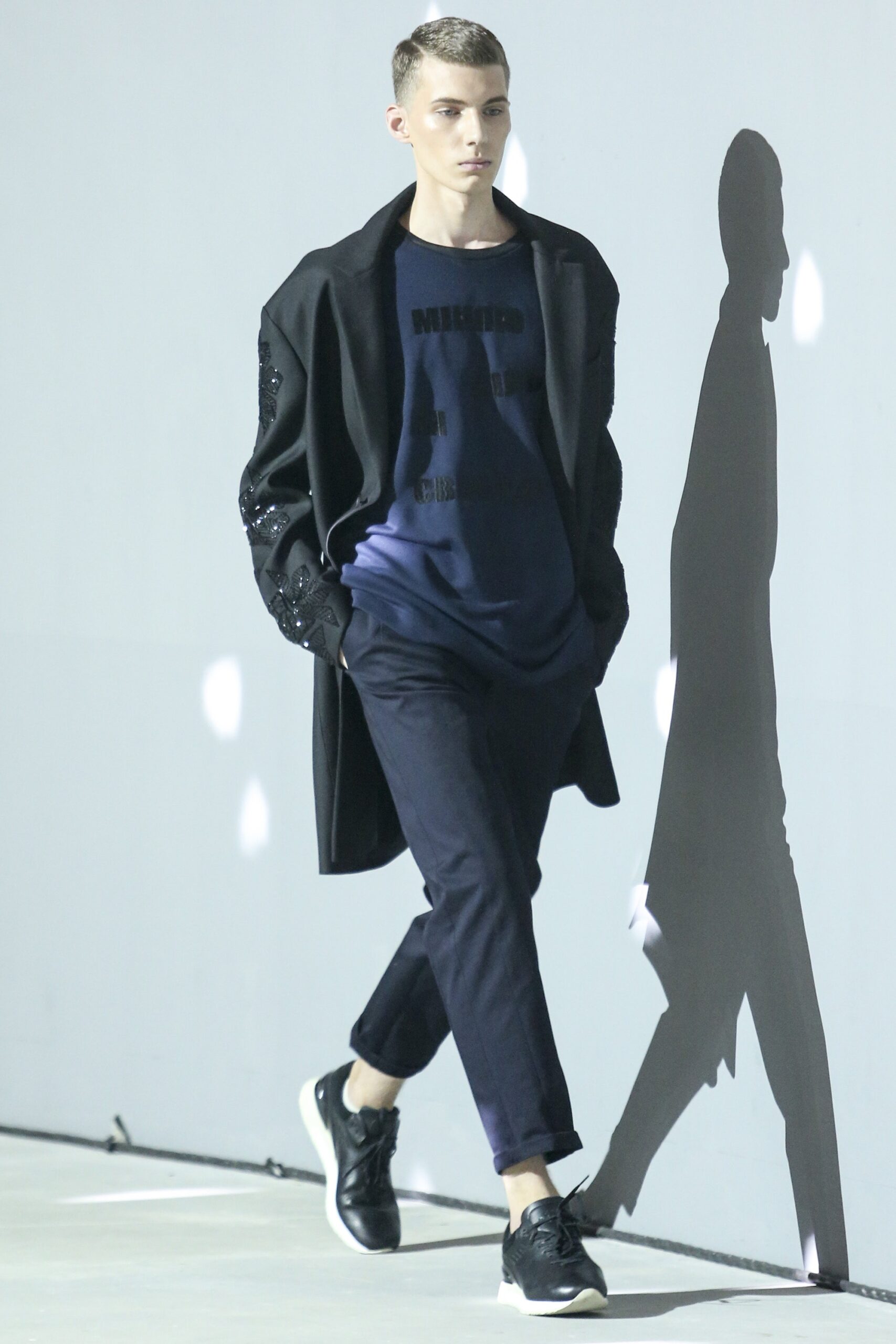 black wool coat with blue t-shirt