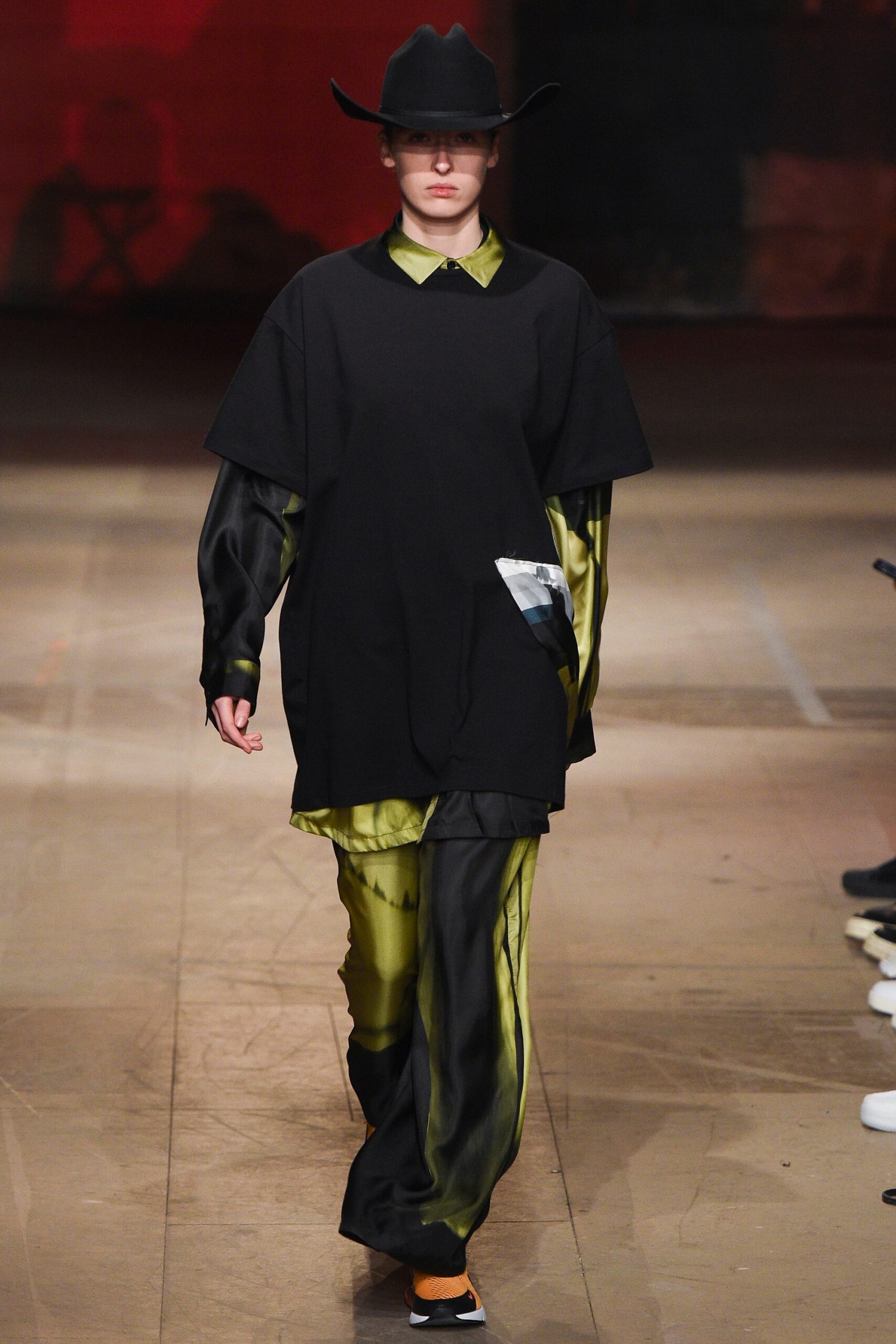 black relaxed top with green flared pants