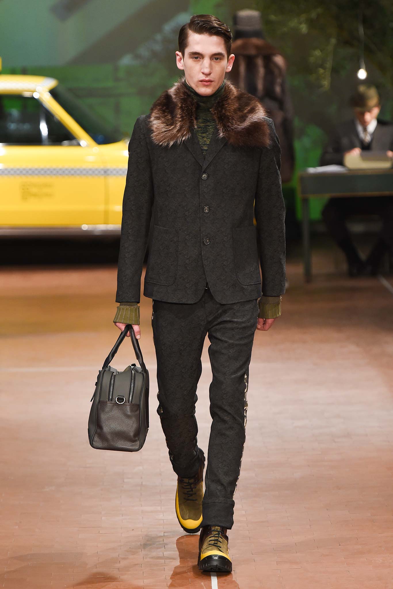 black tailored suit with gold shoes