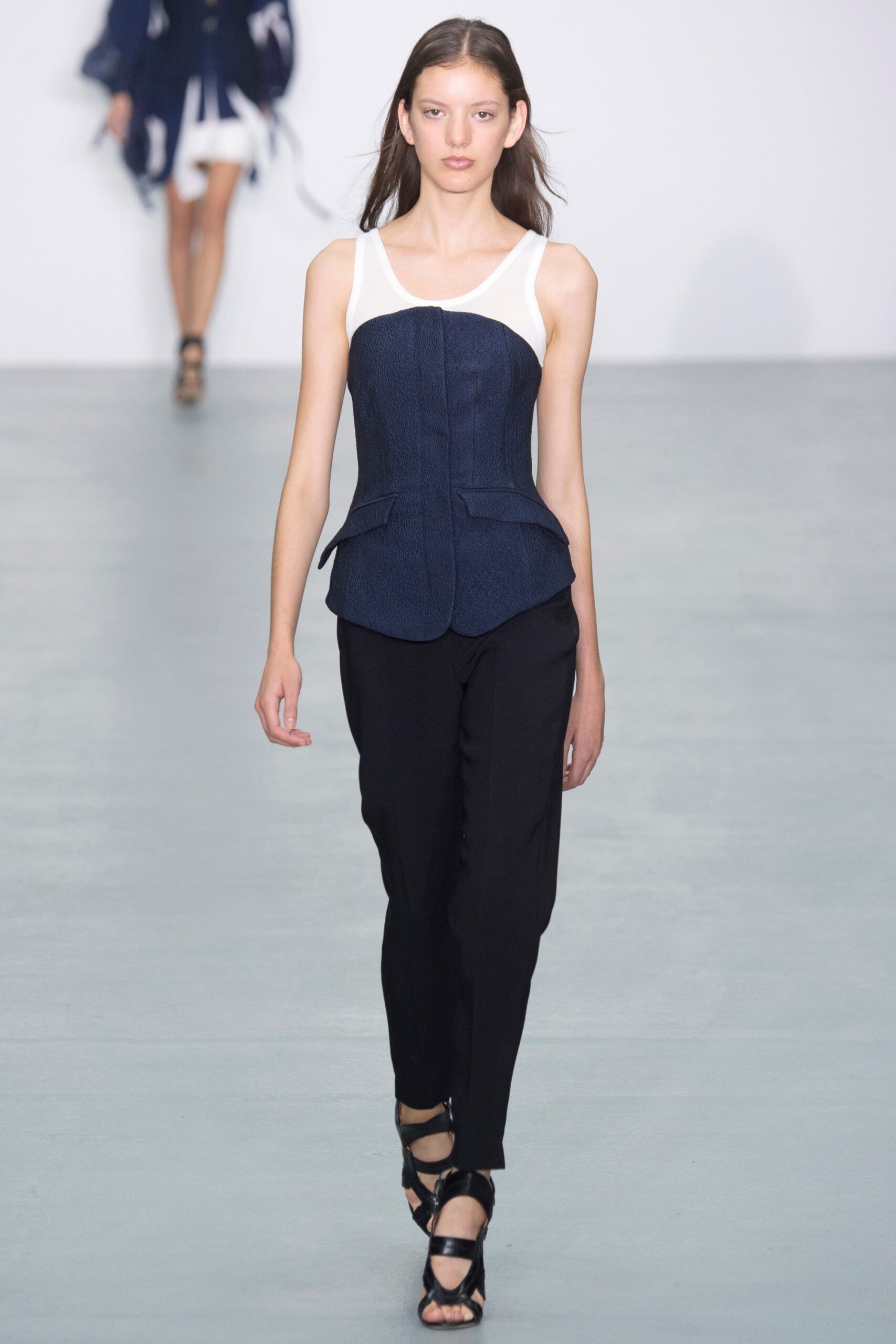blue and white fitted bustier with black slim pants