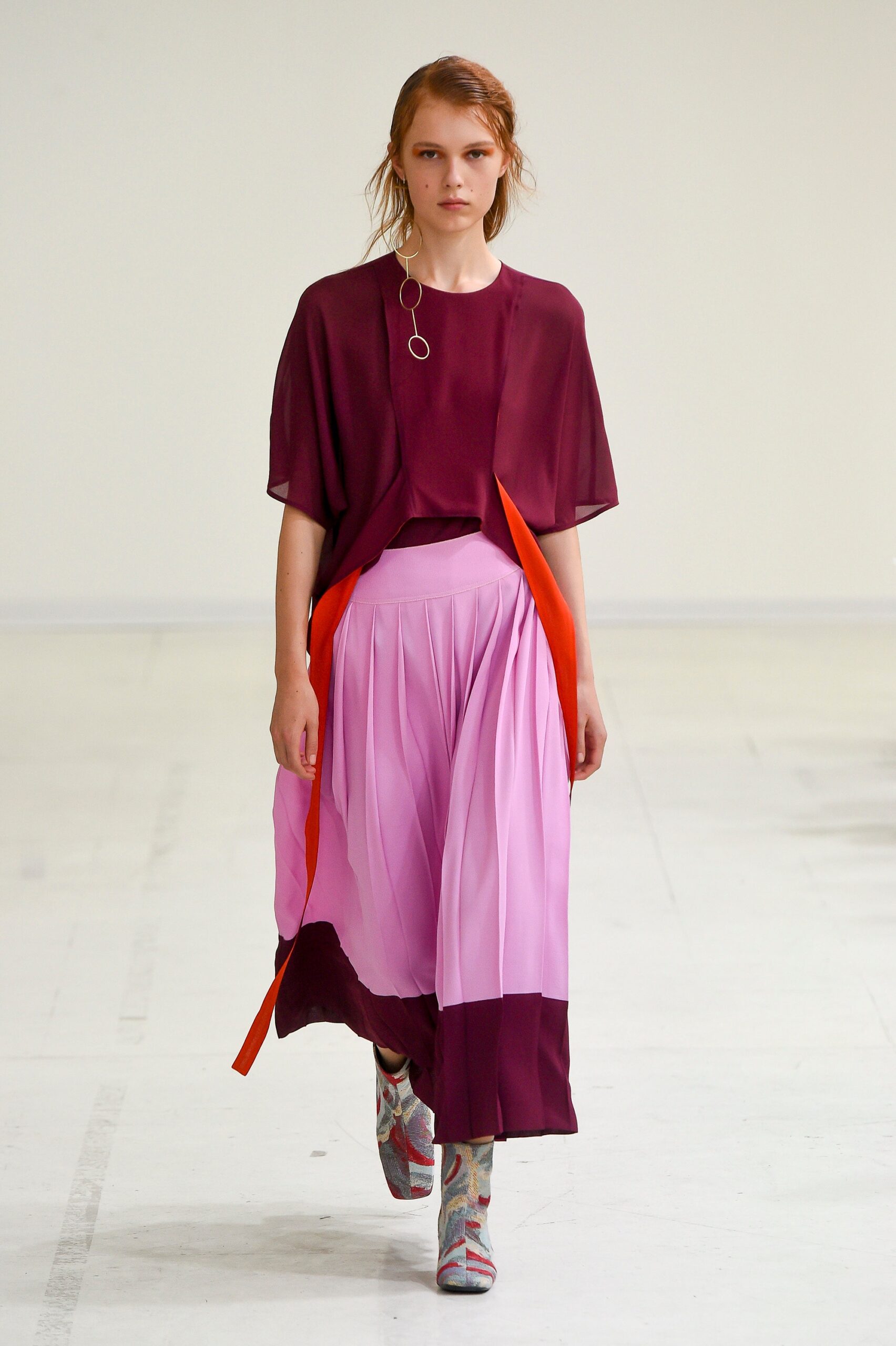 purple layered top with pleated pink skirt
