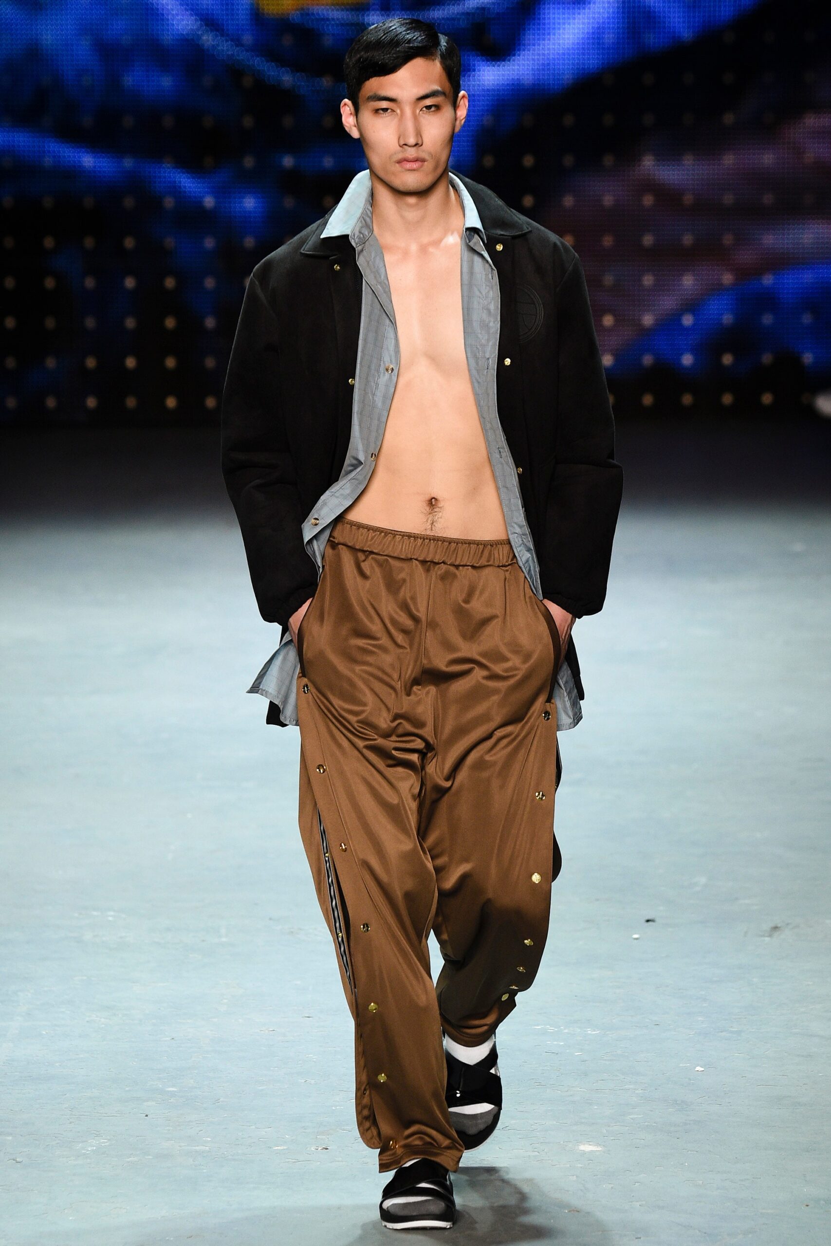 black jacket blue shirt brown pants