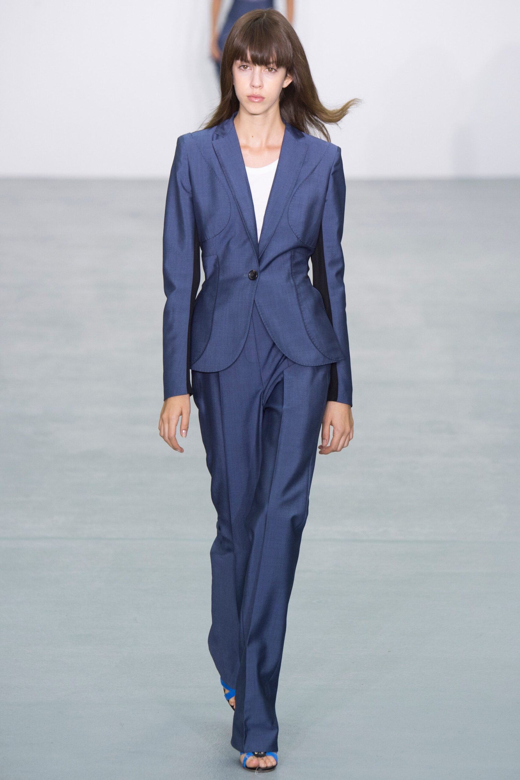 blue tailored suit with white top