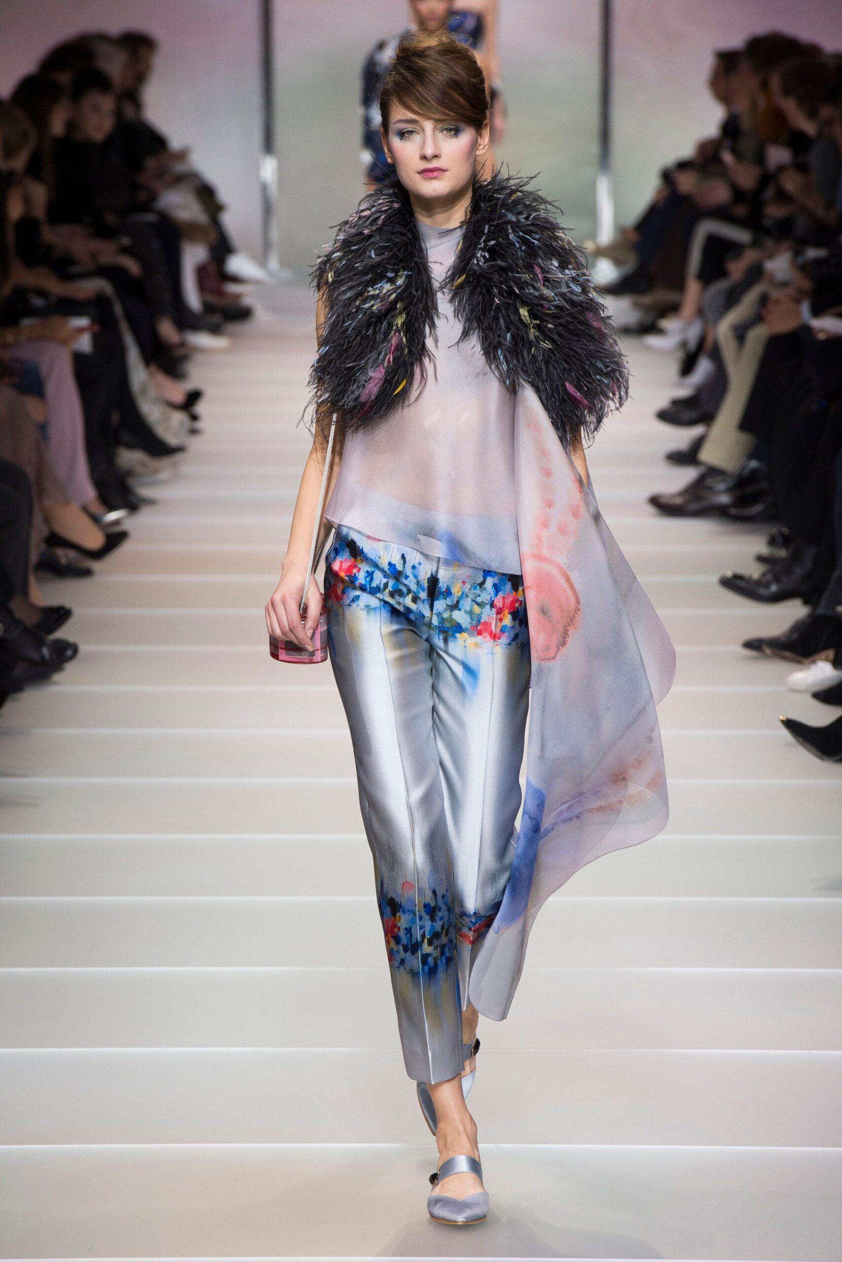 gray silk sleeveless top with feather accessory