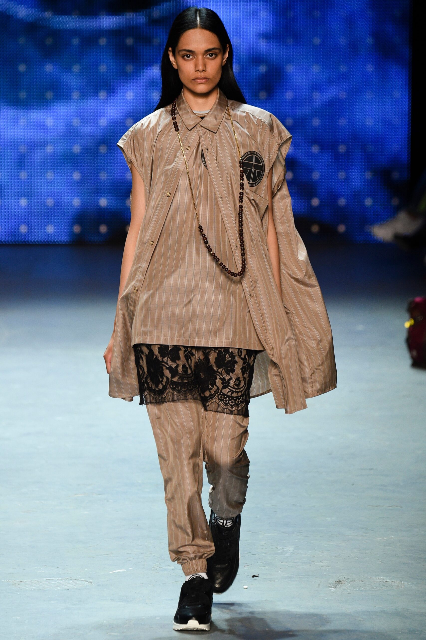 beige striped shirt with black lace skirt