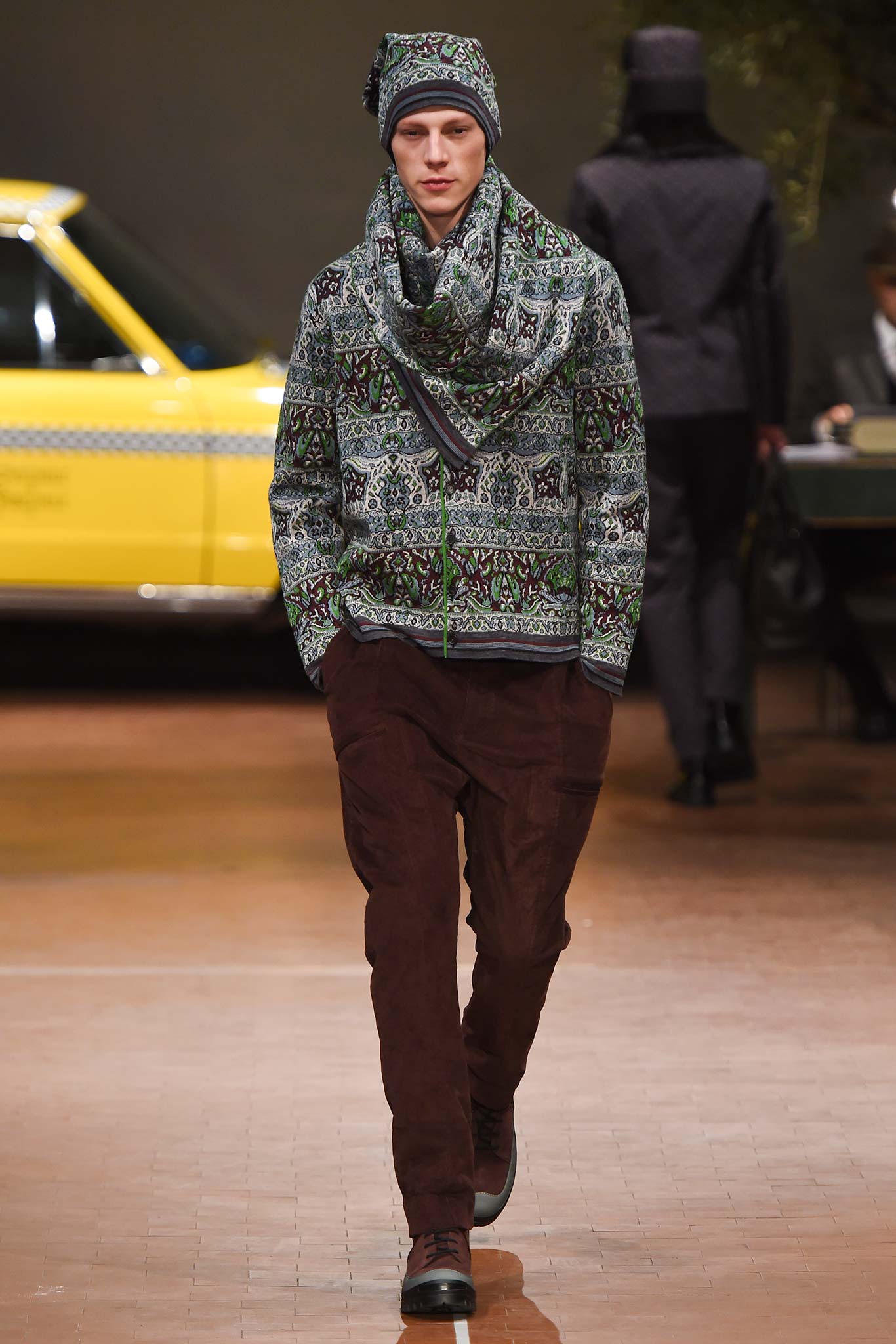 green printed jacket with brown pants