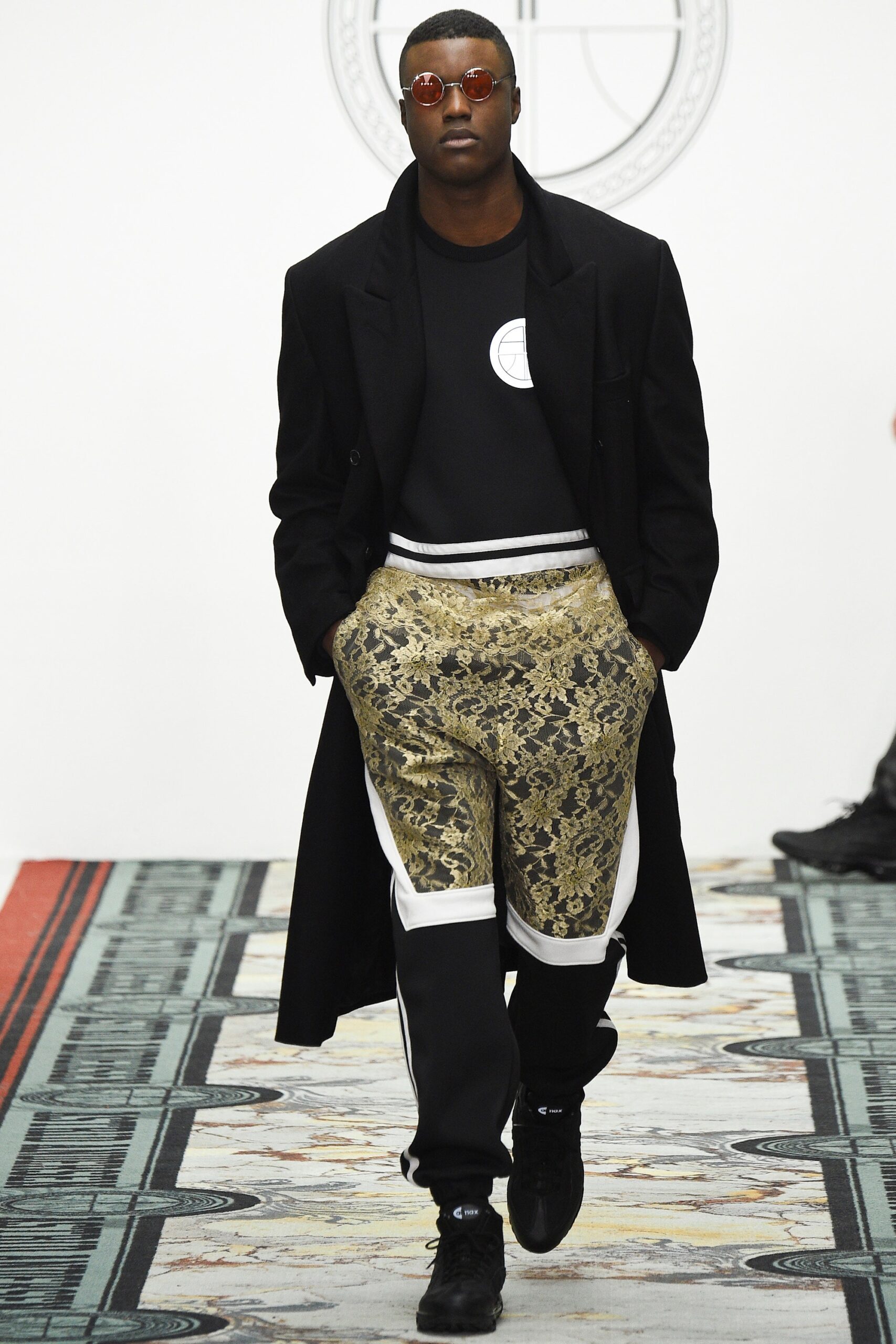 black coat with gold pants