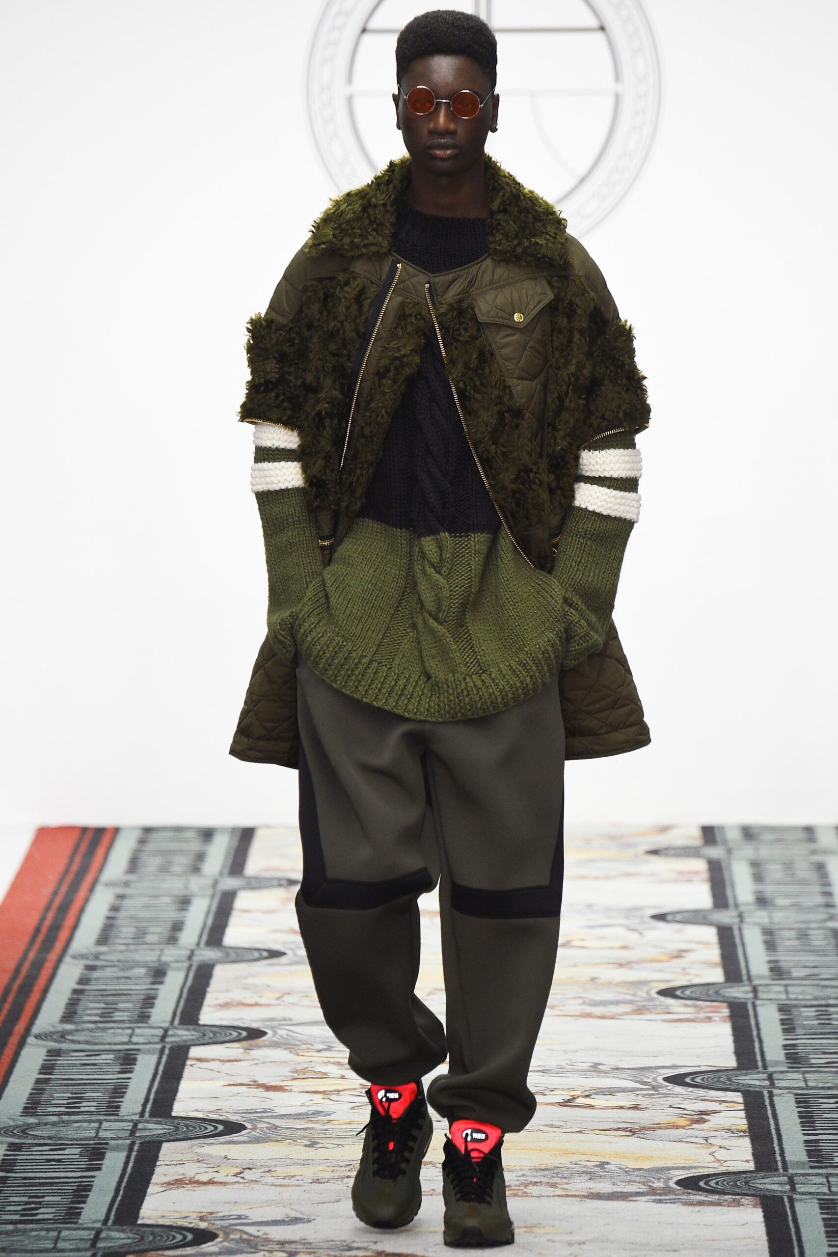 green faux-fur jacket with black sweater