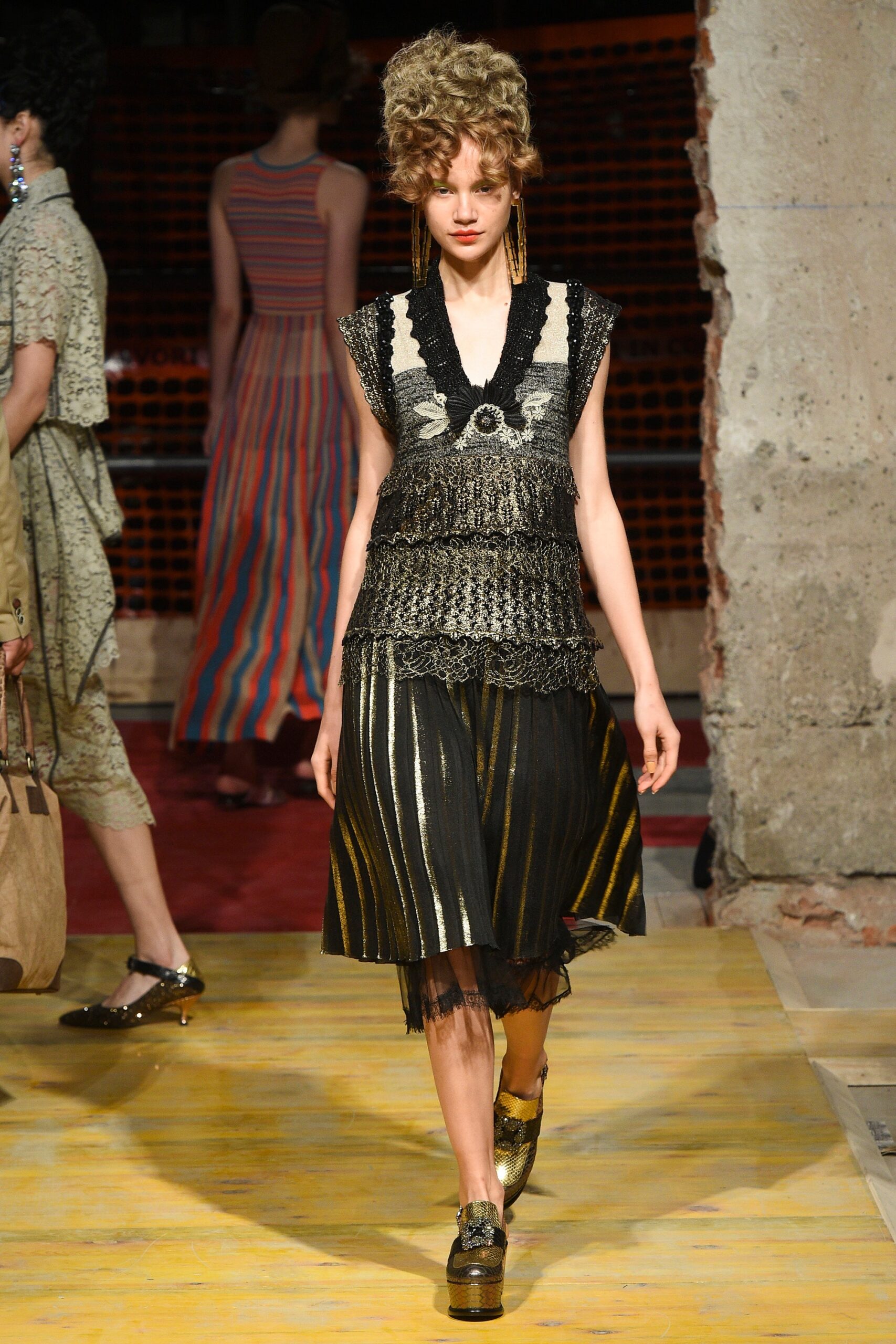 black and gold layered top with pleated skirt