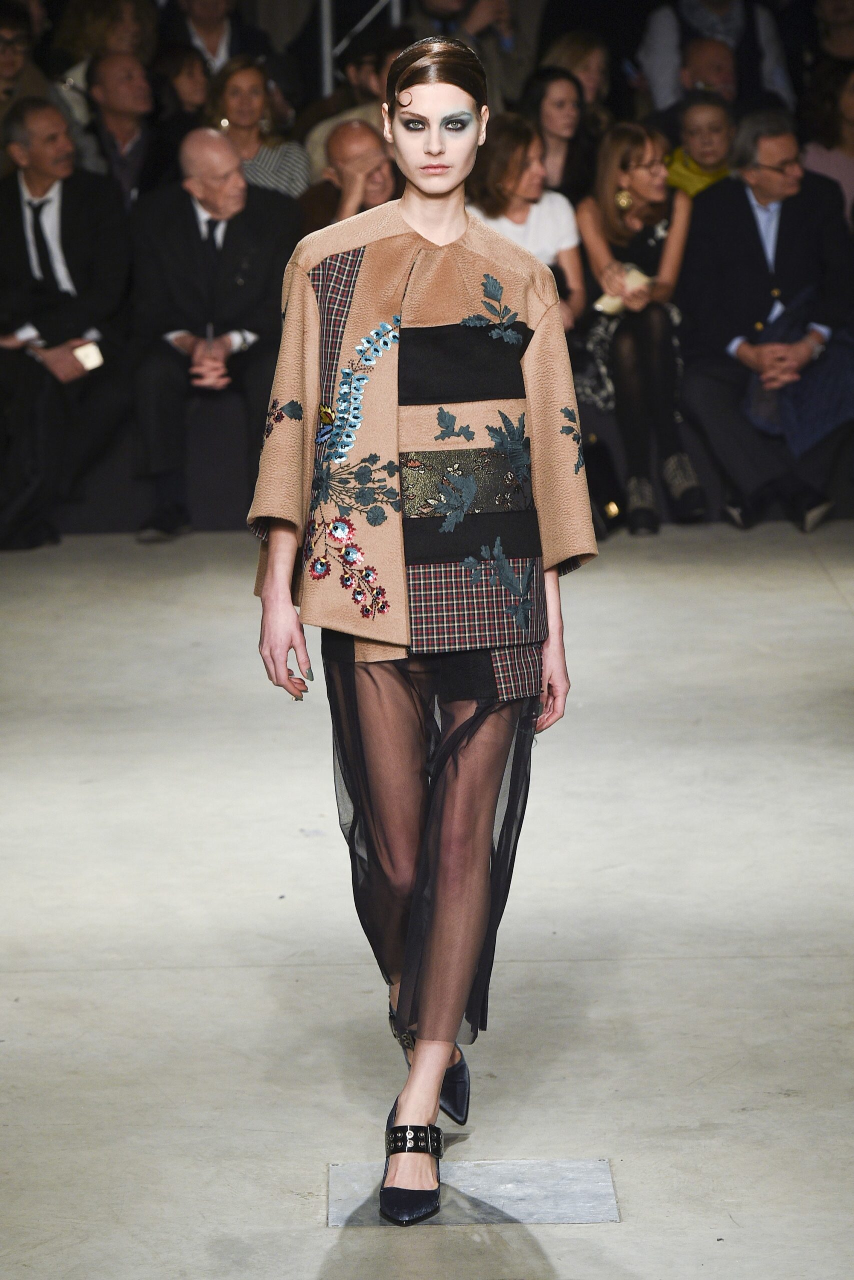 beige embroidered top with black skirt