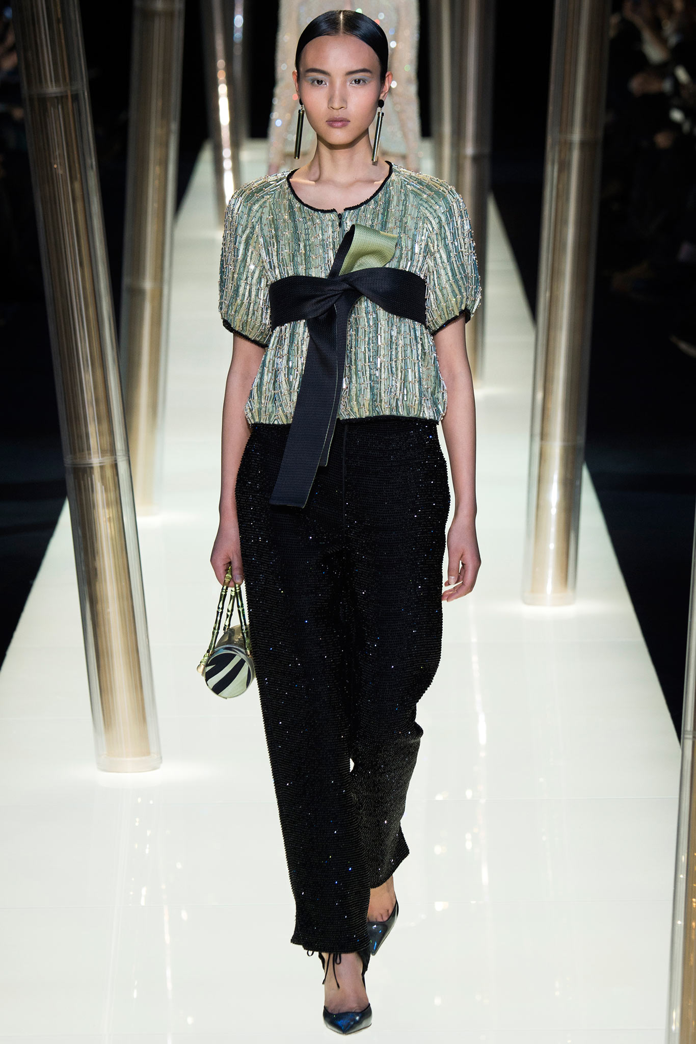 green silk relaxed top with black pants