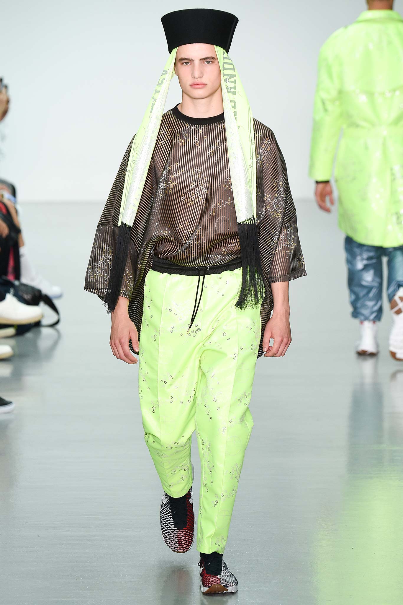 black mesh top and green vinyl pants