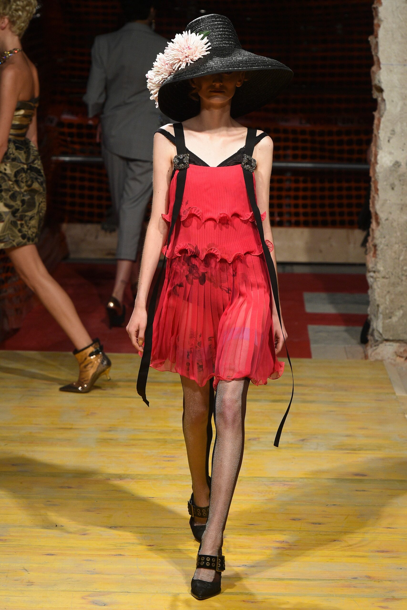 red pleated mini dress with black hat
