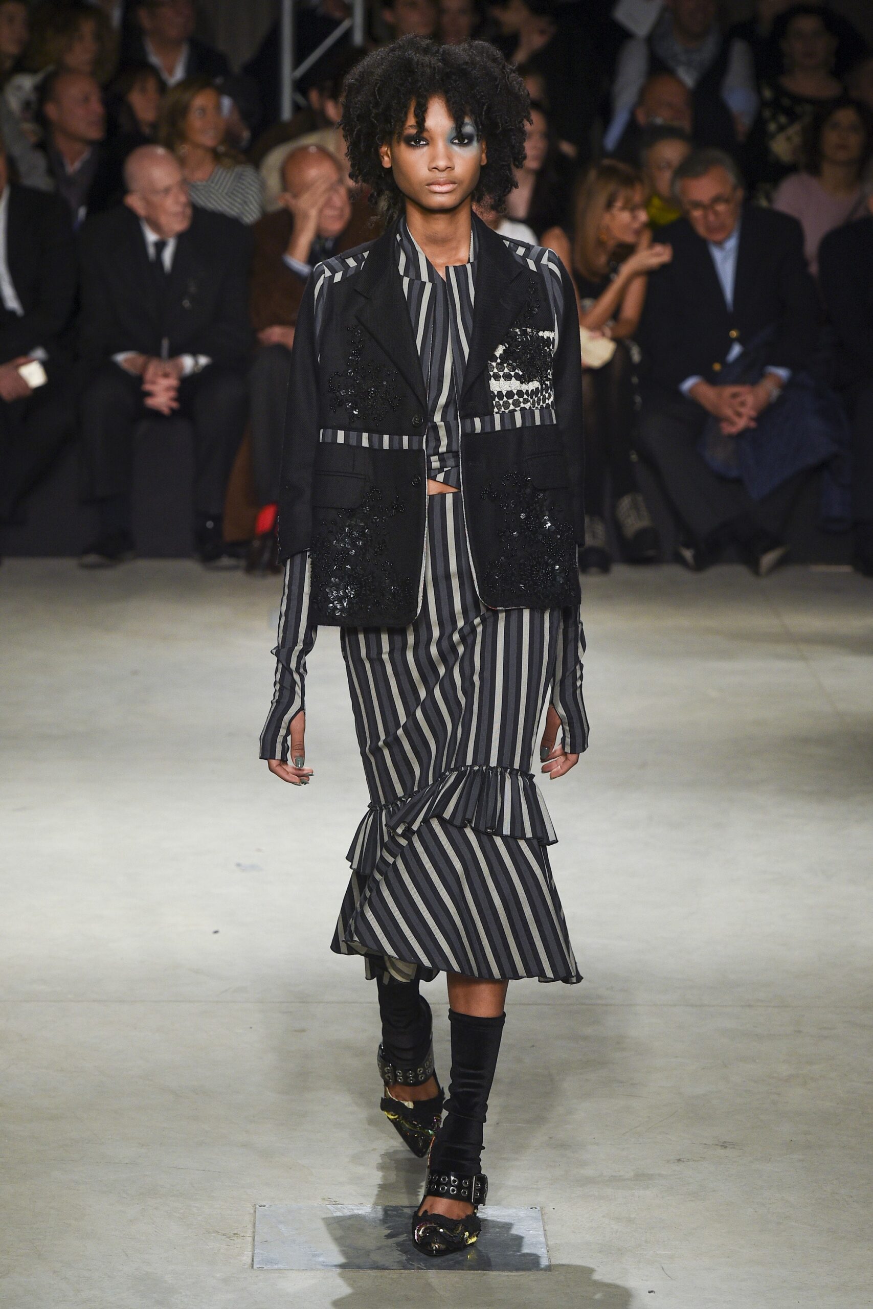 black silk fitted blazer and striped midi skirt