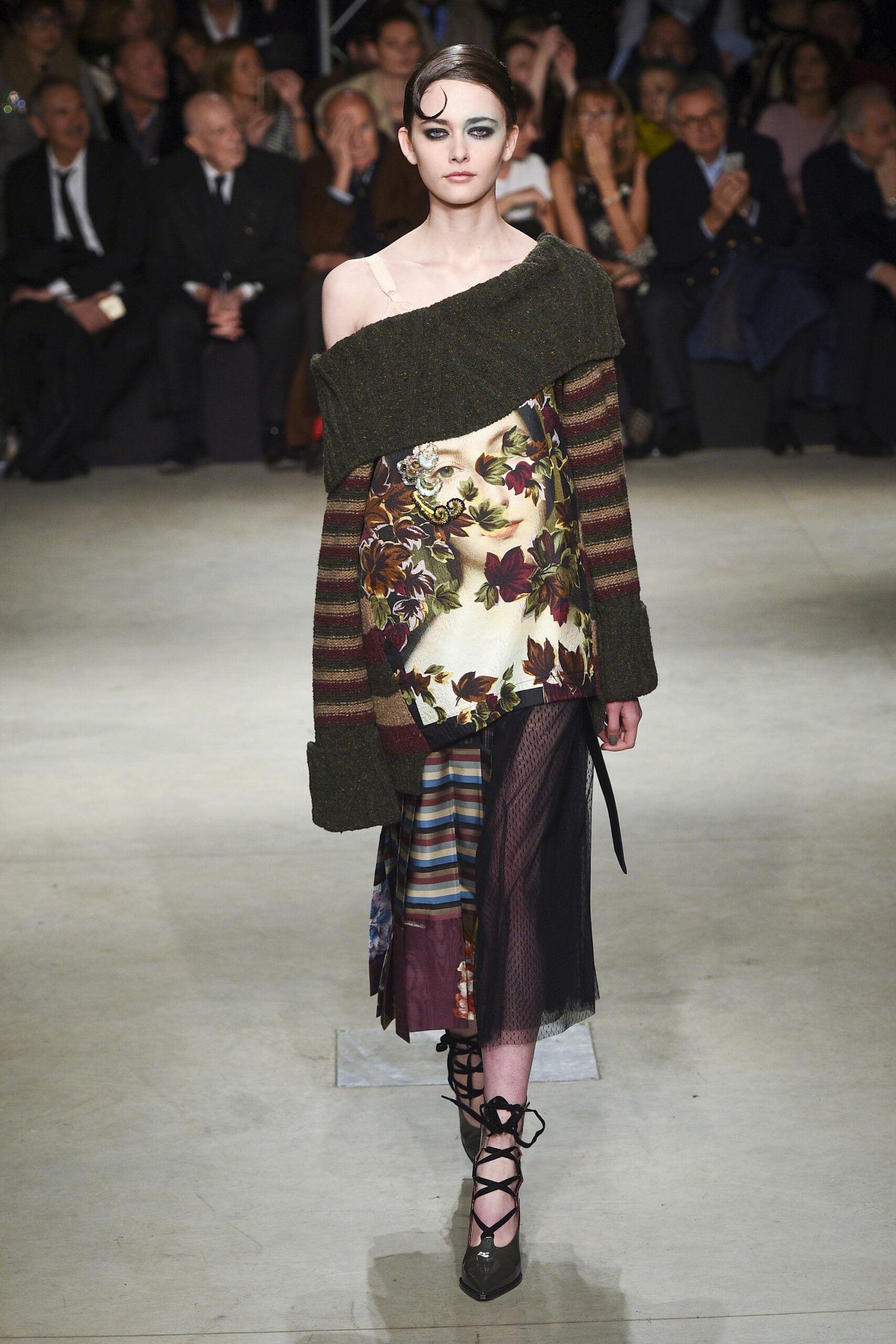 green multi-layered top with black skirt