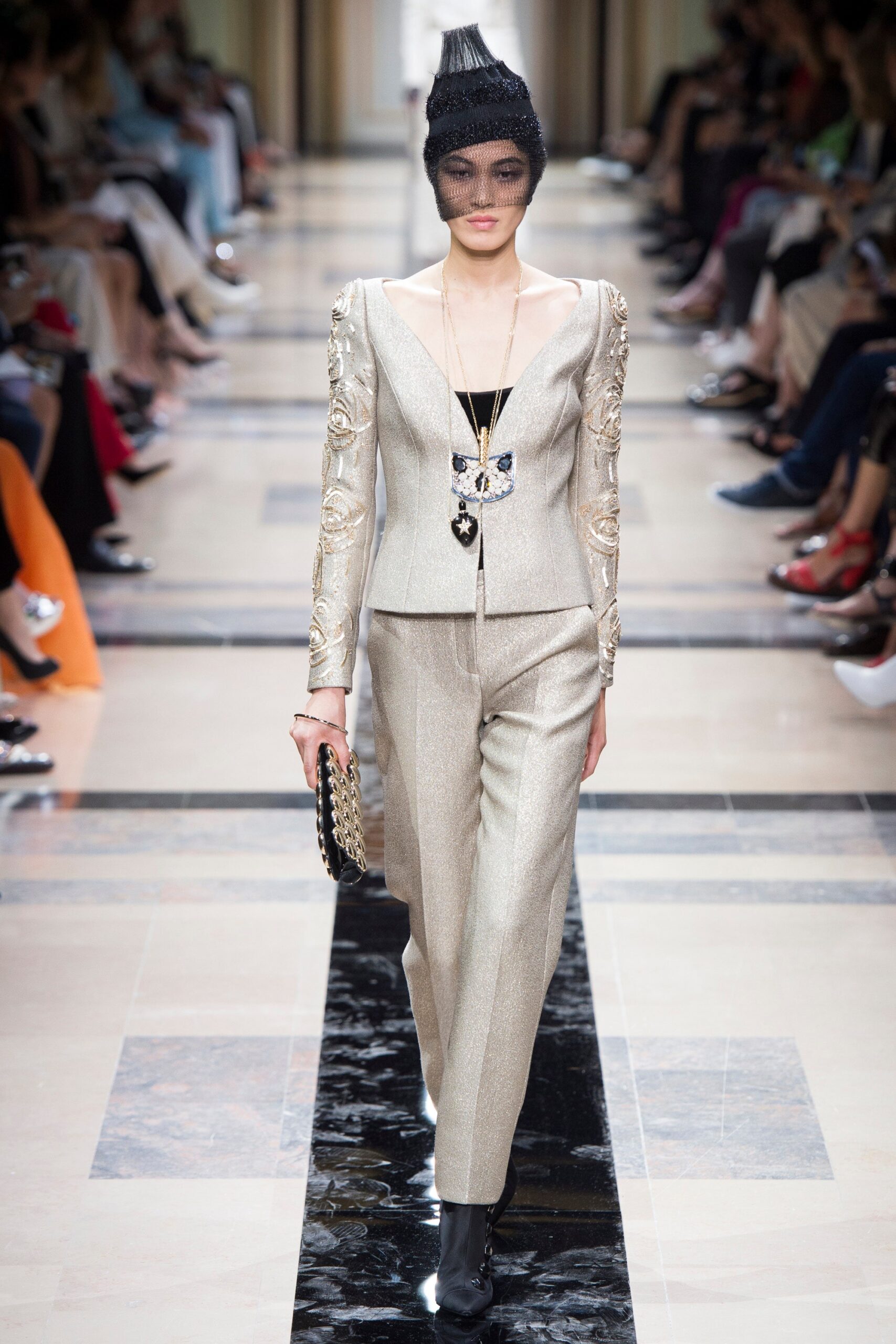 gold tailored suit with clutch