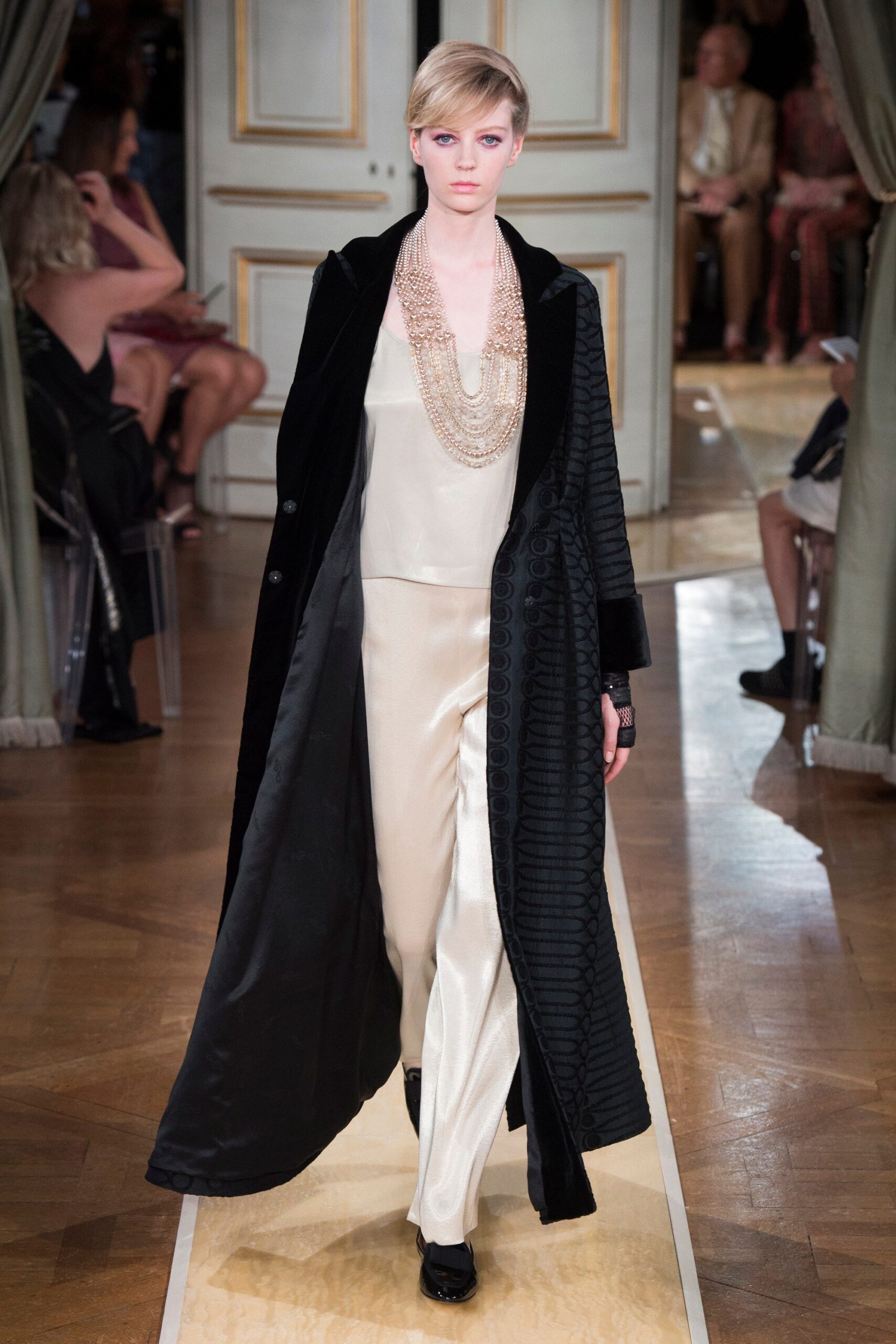 black coat and ivory jumpsuit