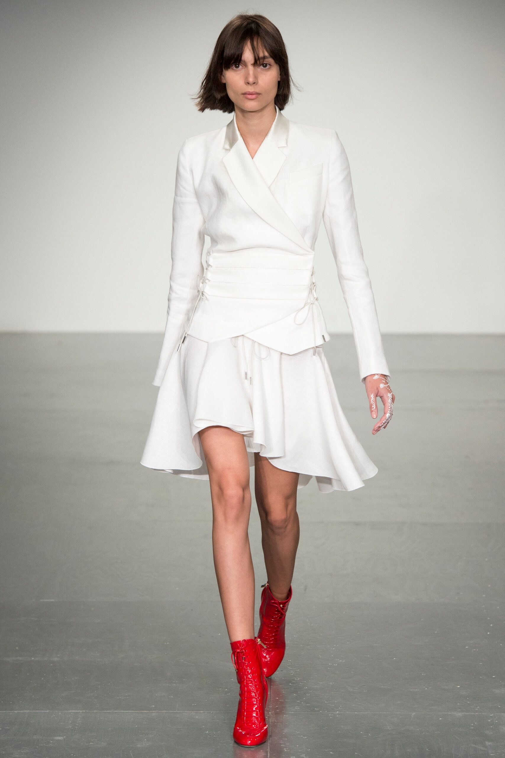 white asymmetric mini dress with red boots
