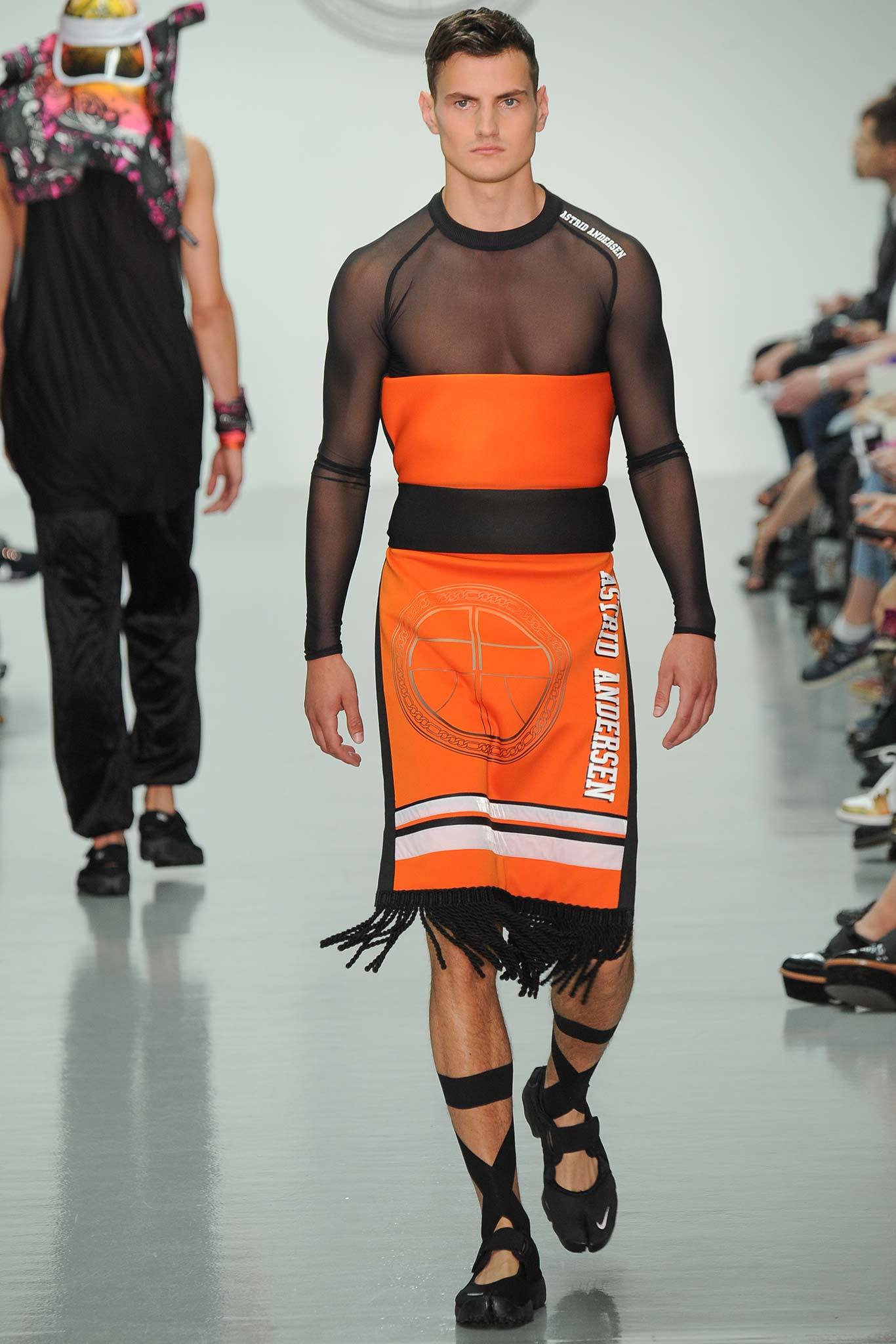 black mesh fitted top and orange skirt