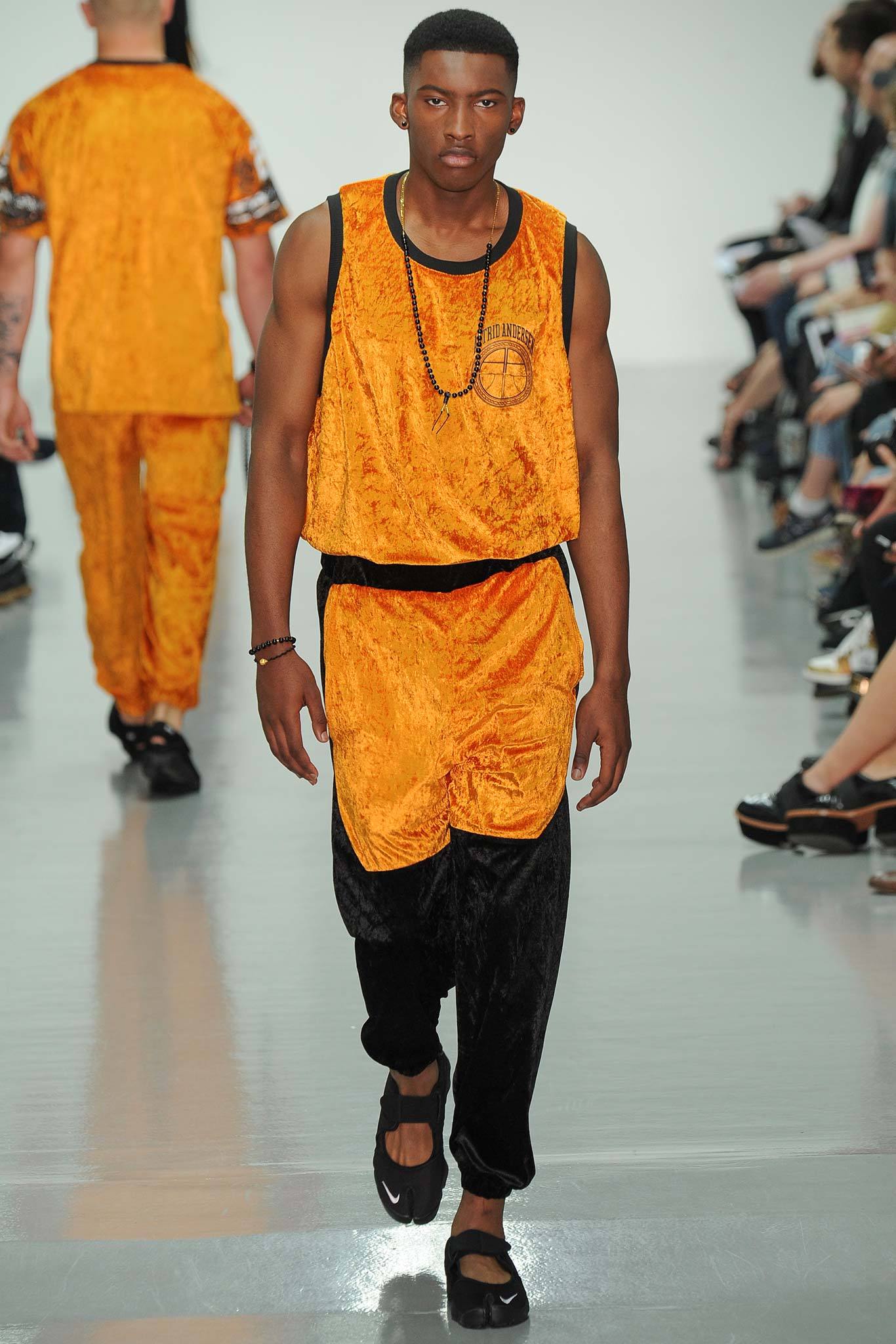 orange velvet tank-top and black pants