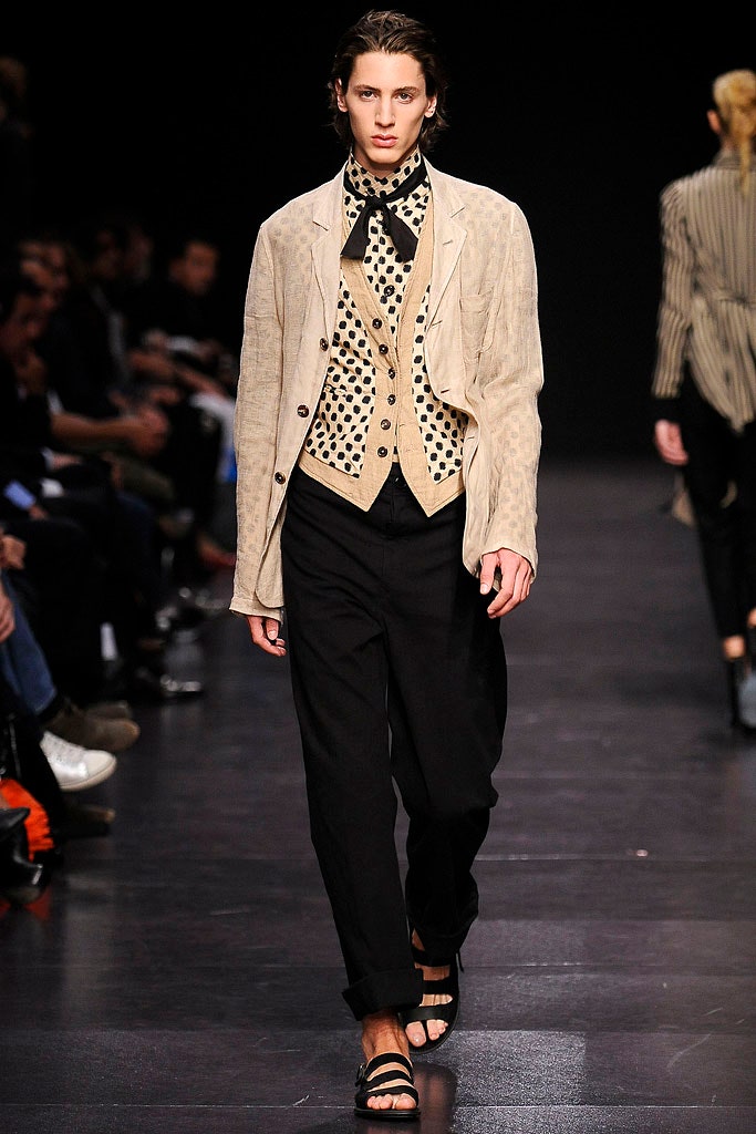beige jacket tan vest black pants