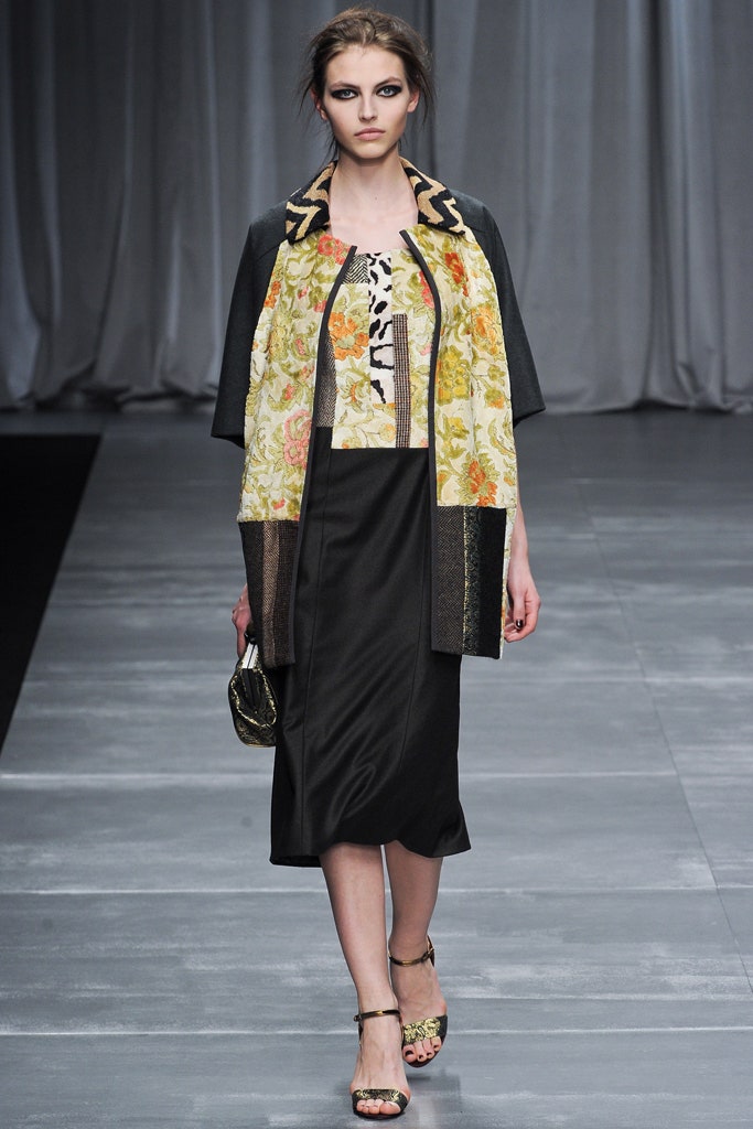 black fitted midi dress with multi-colored cape