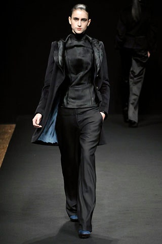 black fitted coat and top with tailored pants