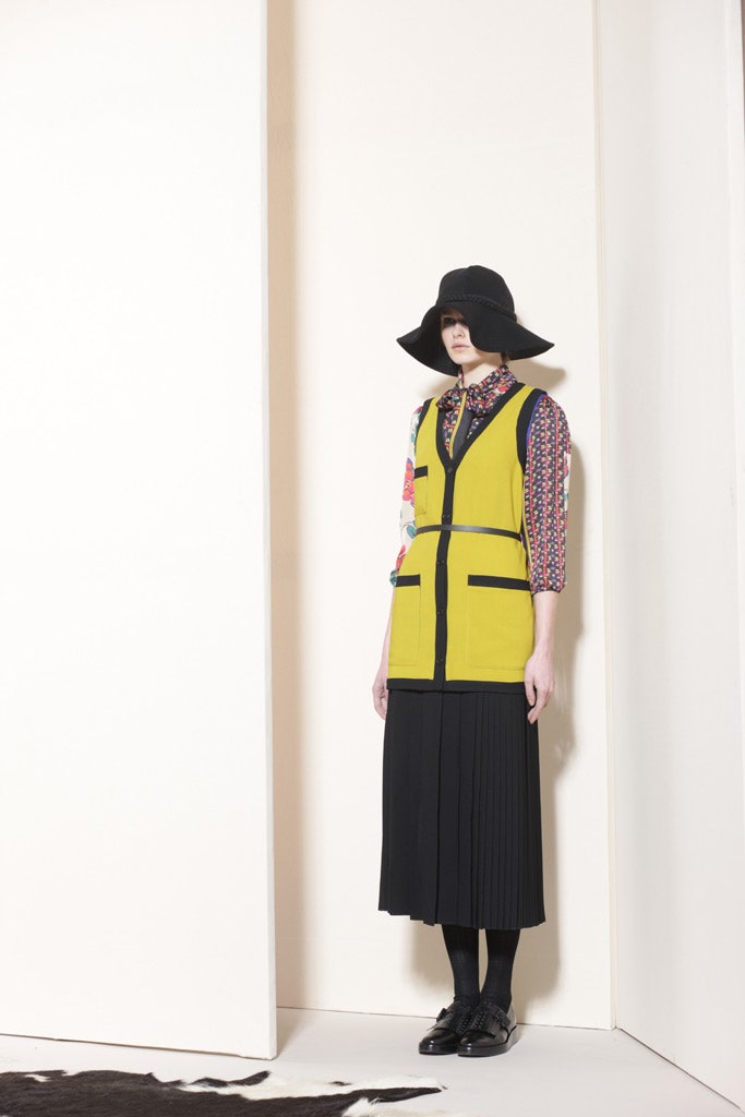 yellow vest with black skirt