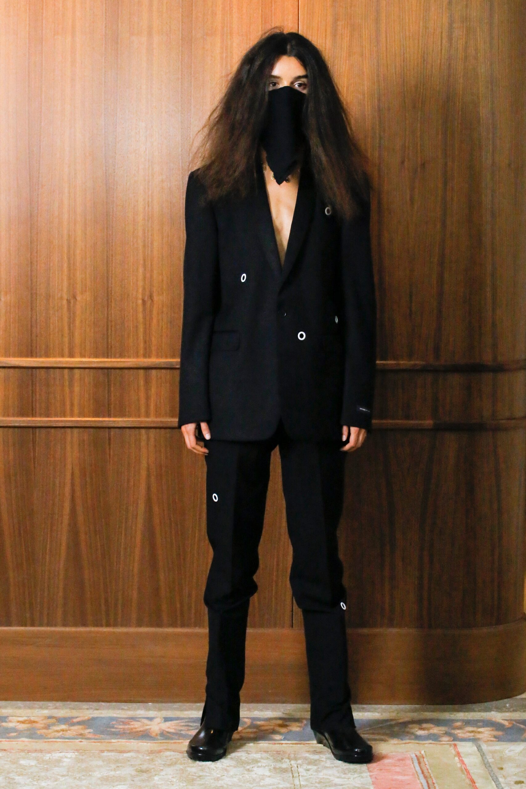 black tailored suit with mask