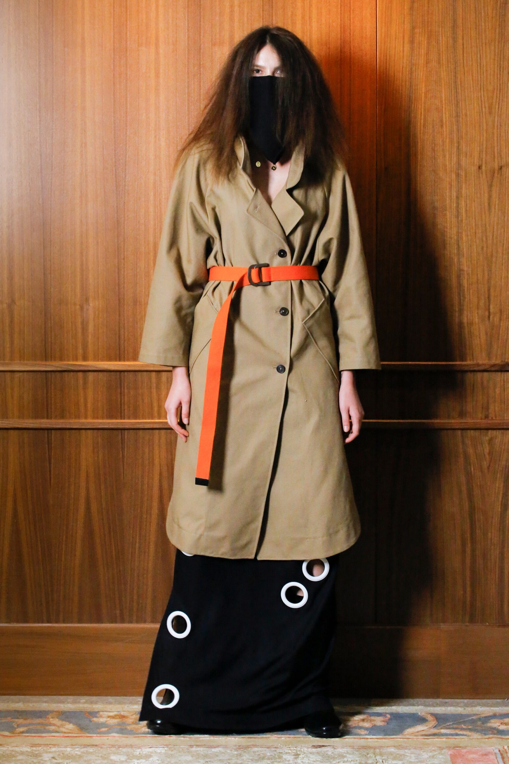 beige trench coat and black skirt