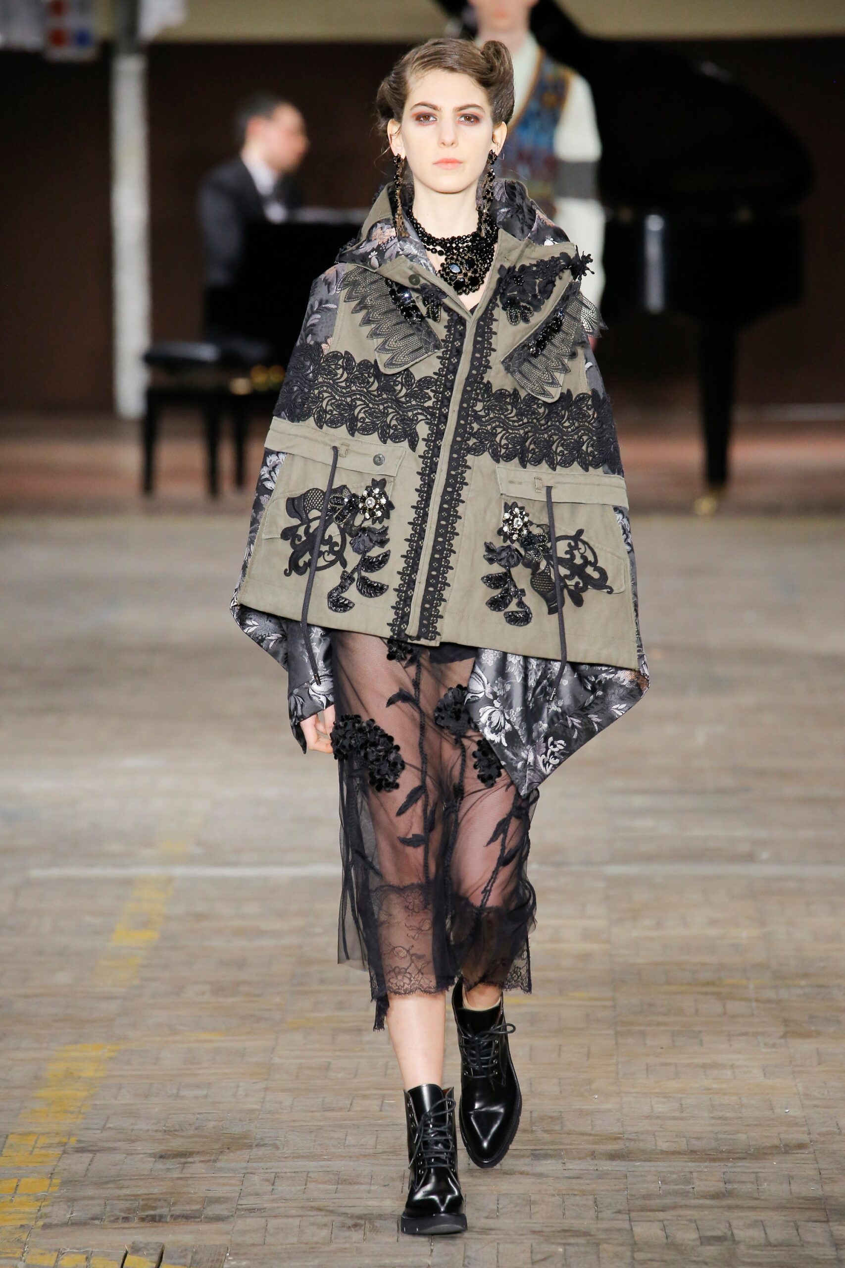 gray embroidered cape and black lace dress