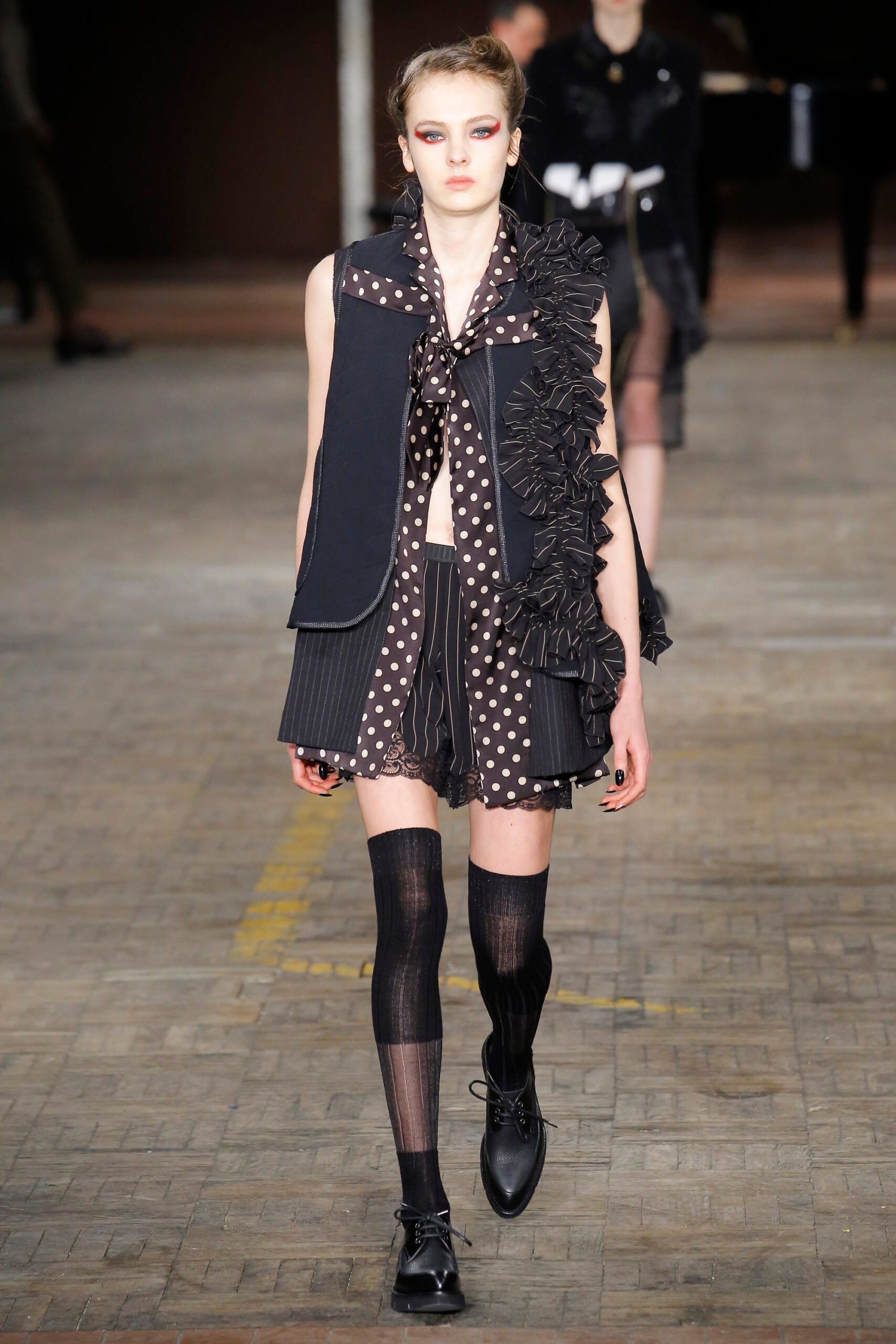 black fitted vest and skirt