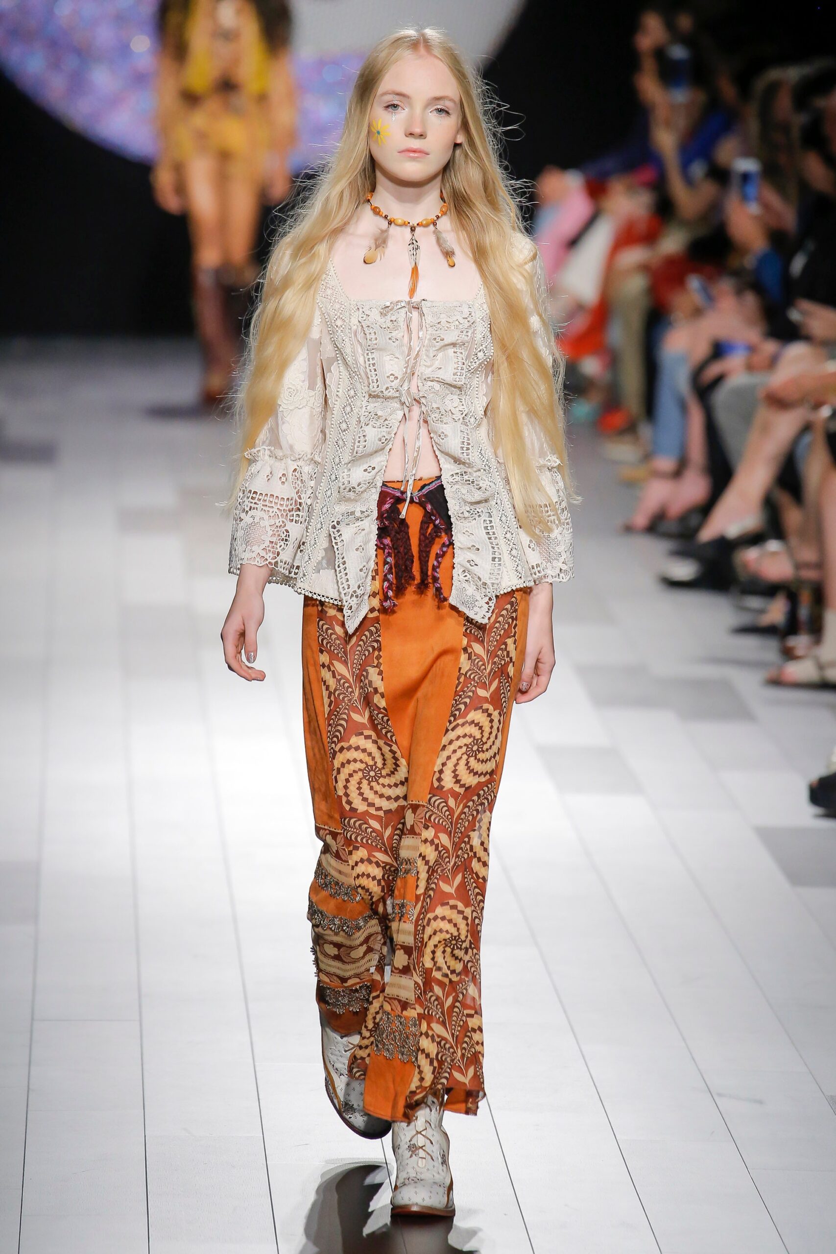 white embroidered blouse and orange flared pants
