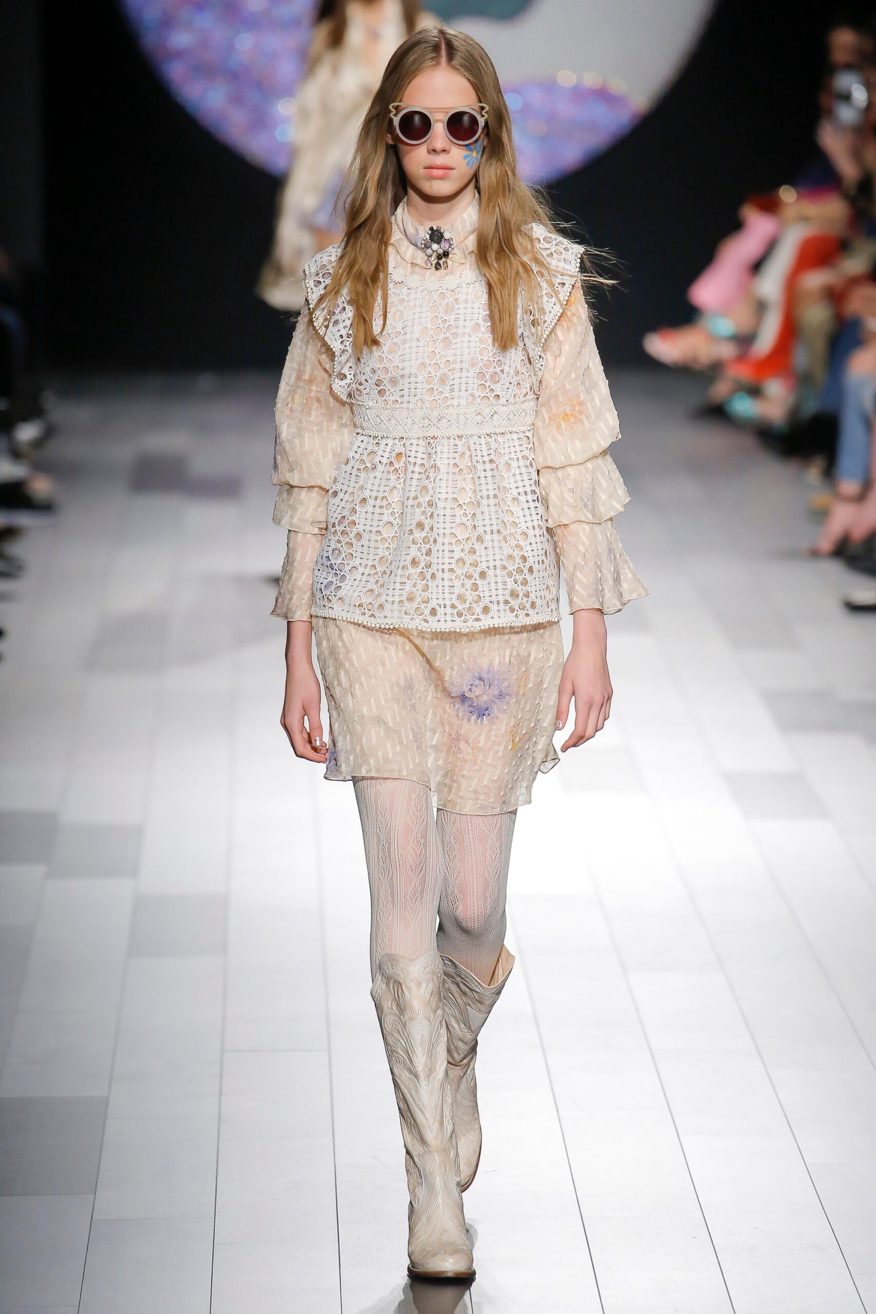 white lace fitted blouse with beige boots