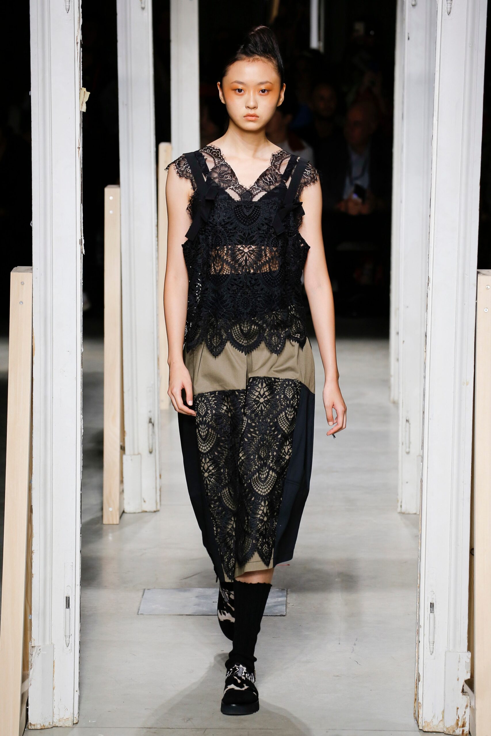 black lace sleeveless top and beige wide-leg pants