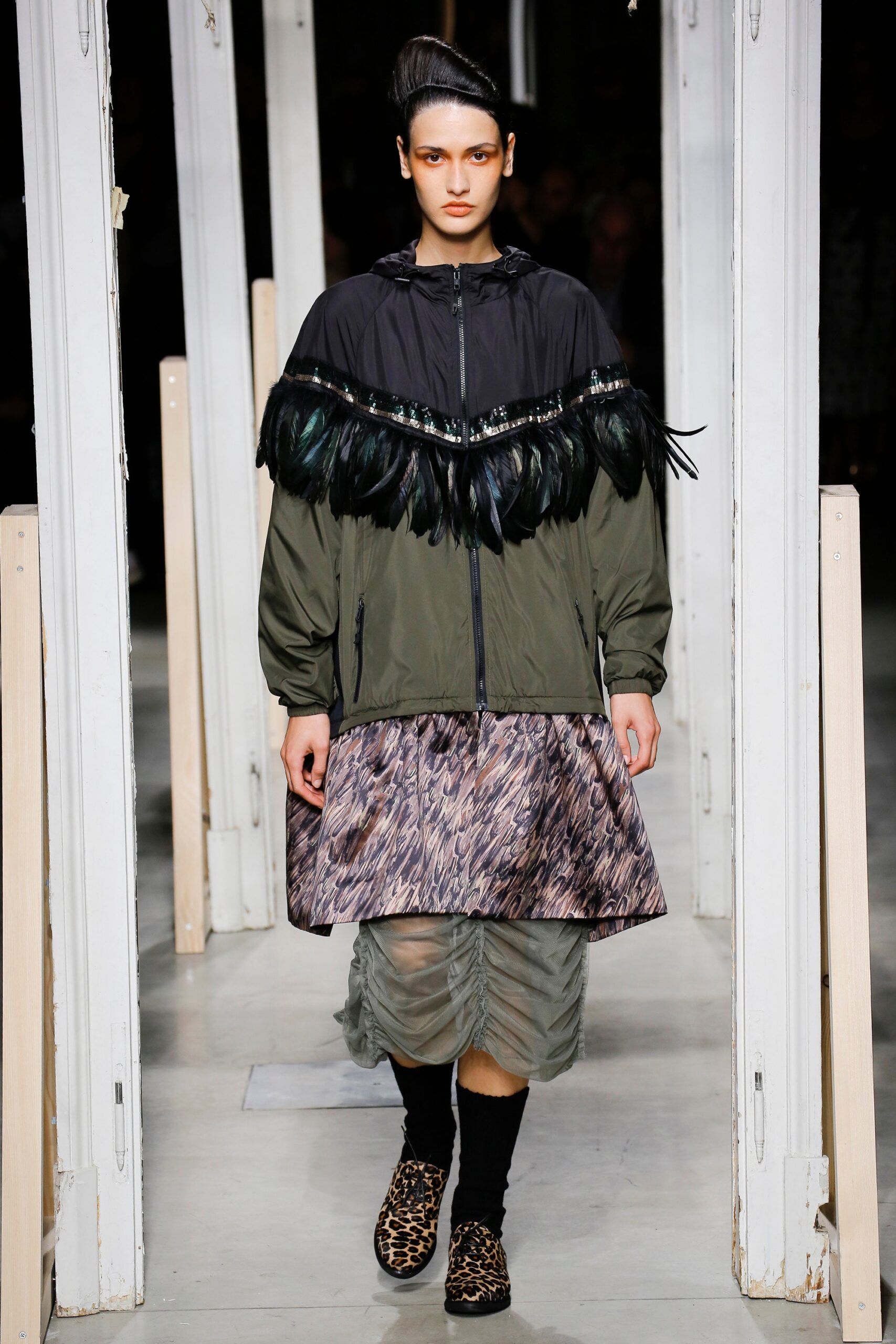 black green fringed jacket and pleated skirt