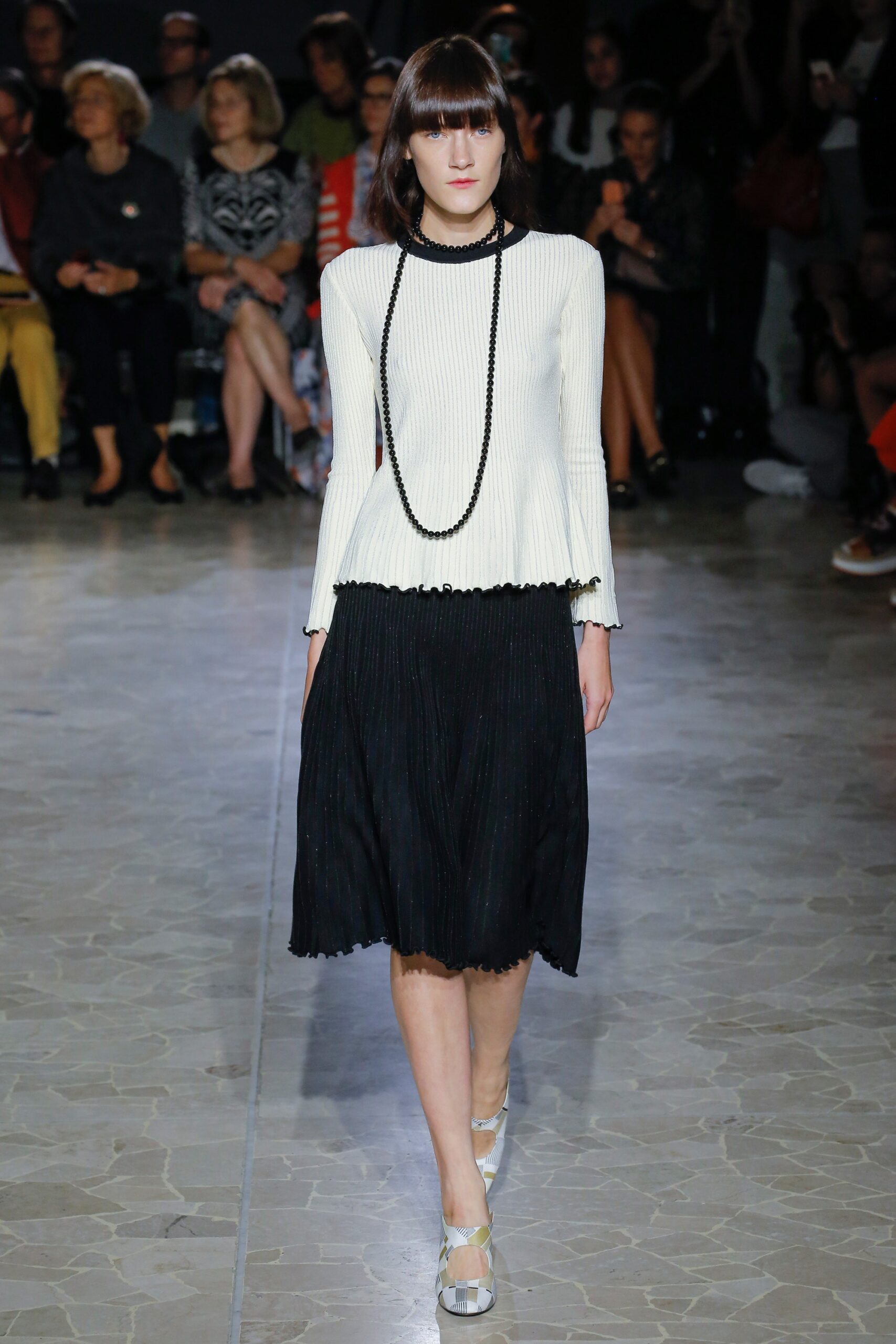 white fitted top with black skirt