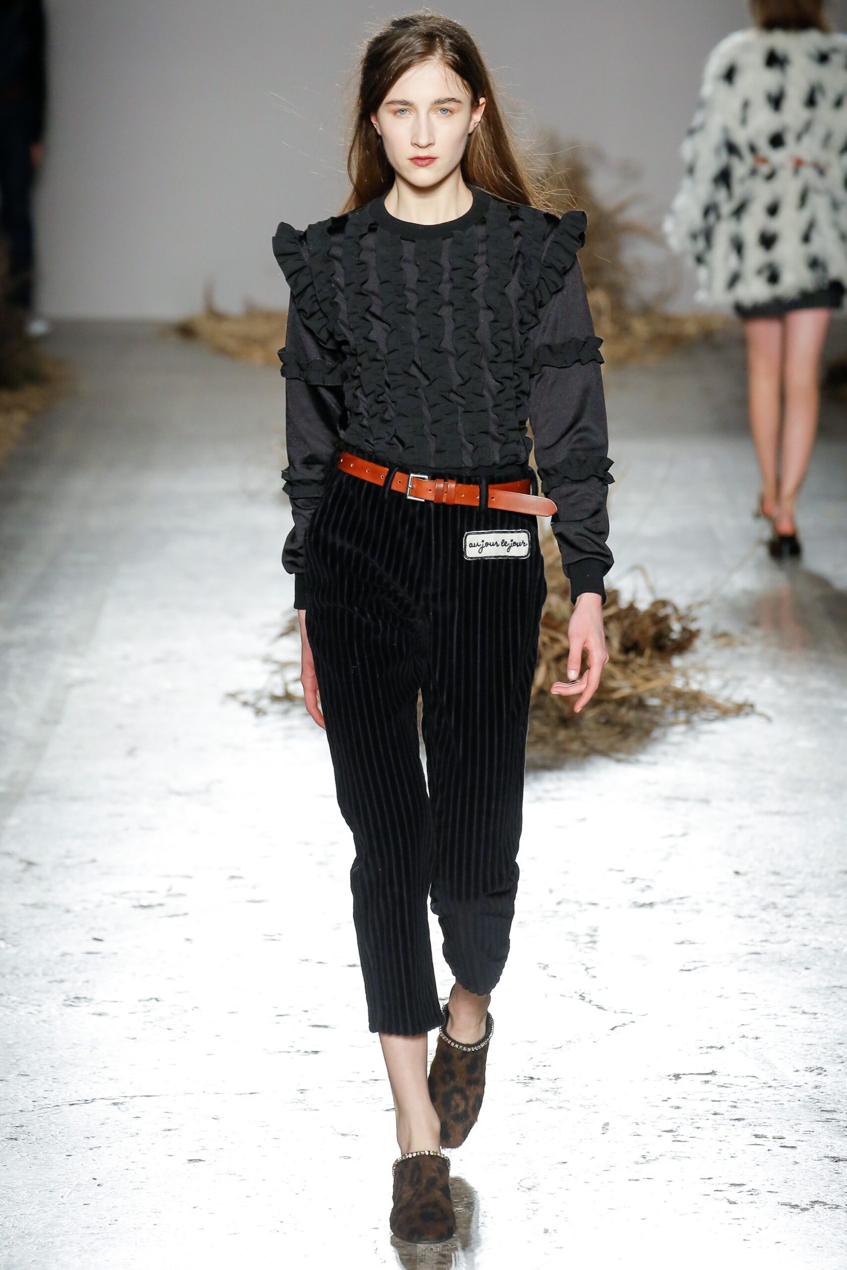 black ruffled top with striped pants