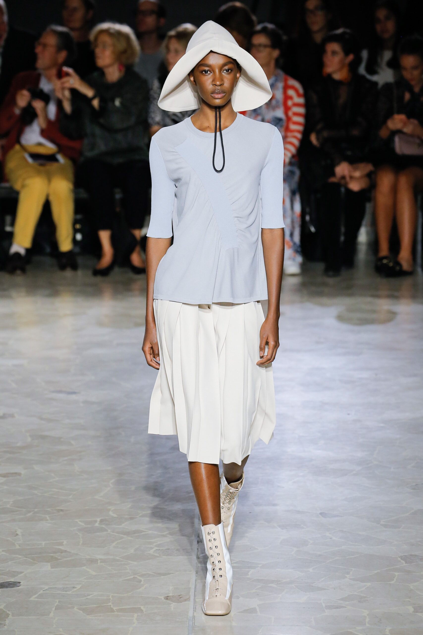 blue fitted top with white pleated skirt
