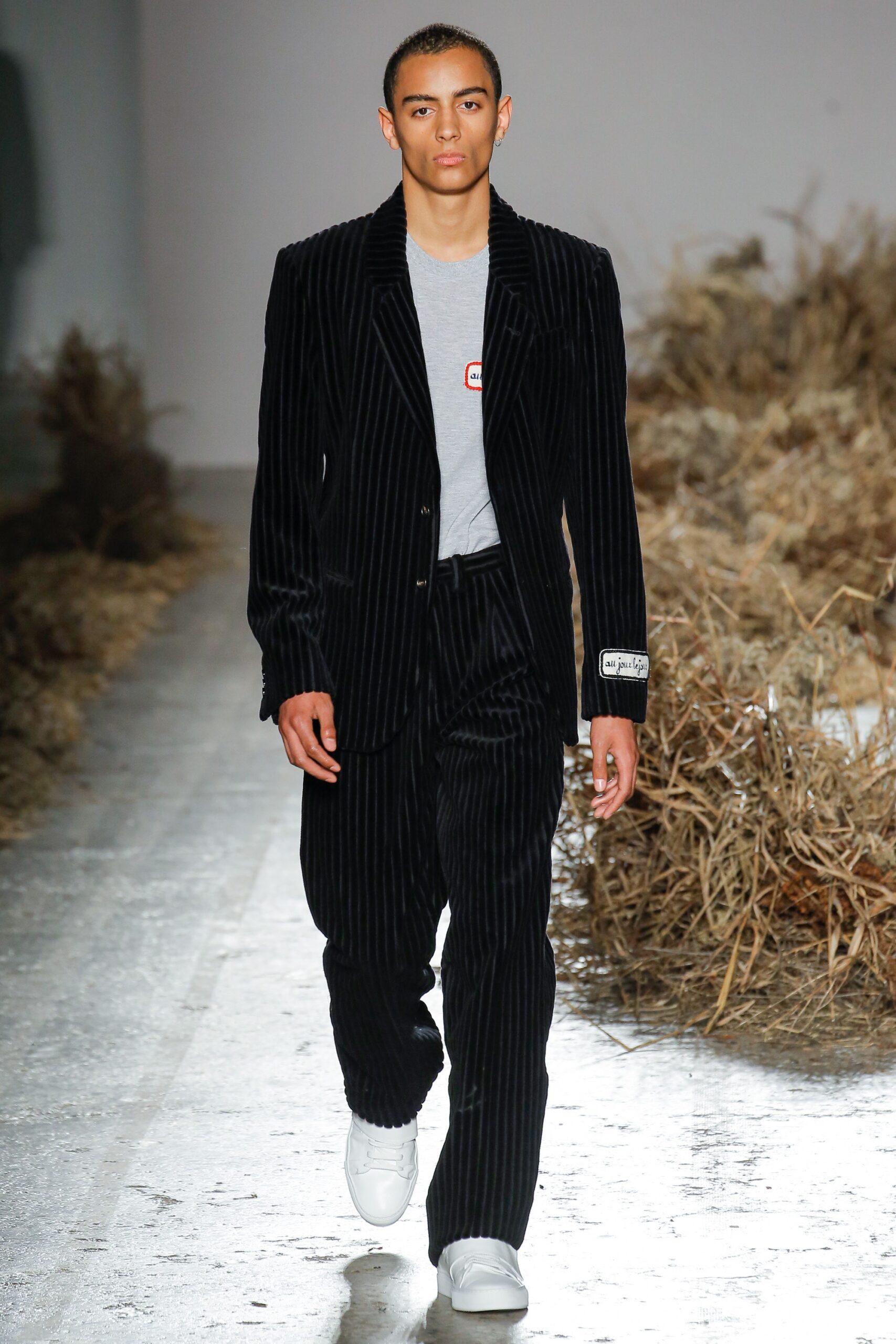 black striped tailored suit with gray t-shirt