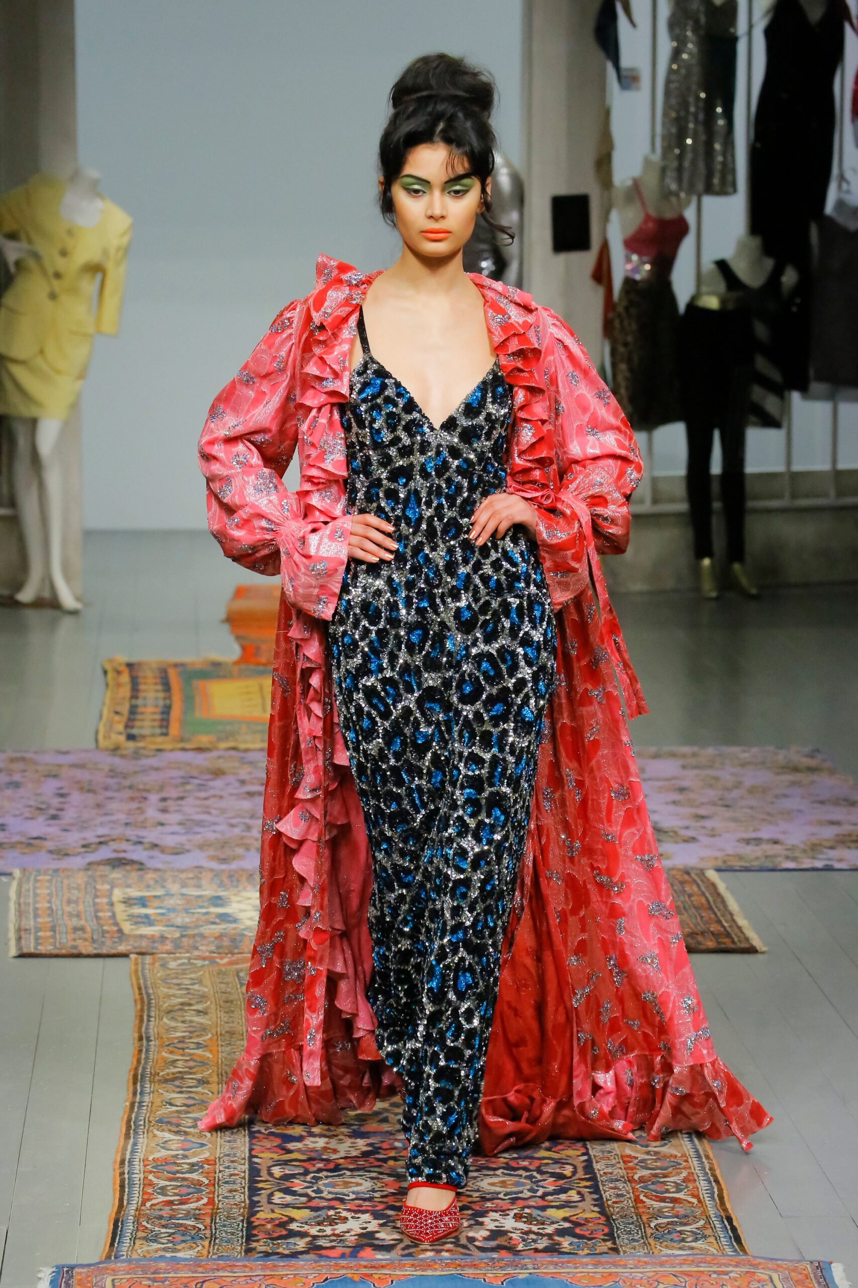 blue sequined gown with red cape