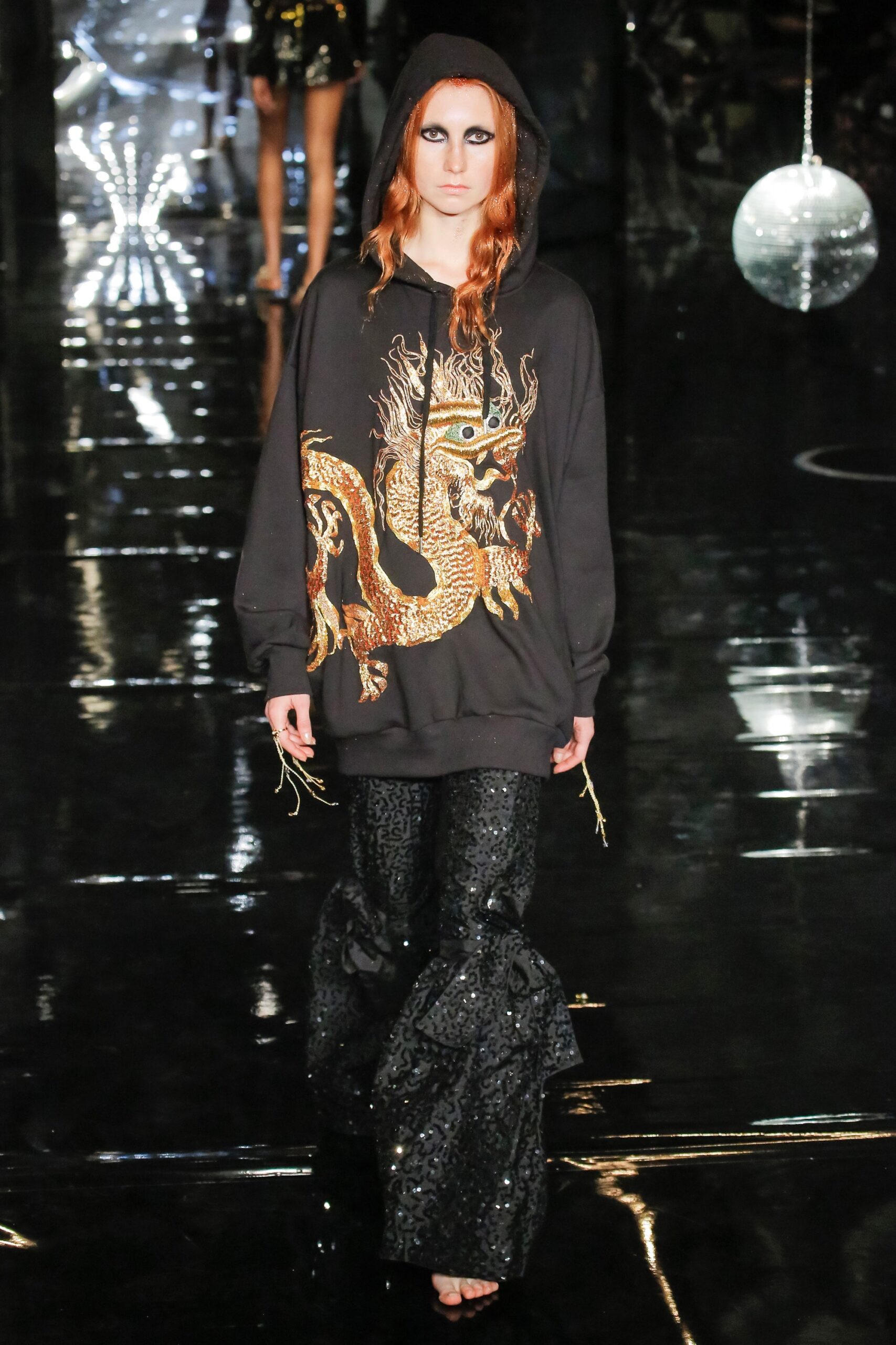 black embroidered hoodie and sequined pants
