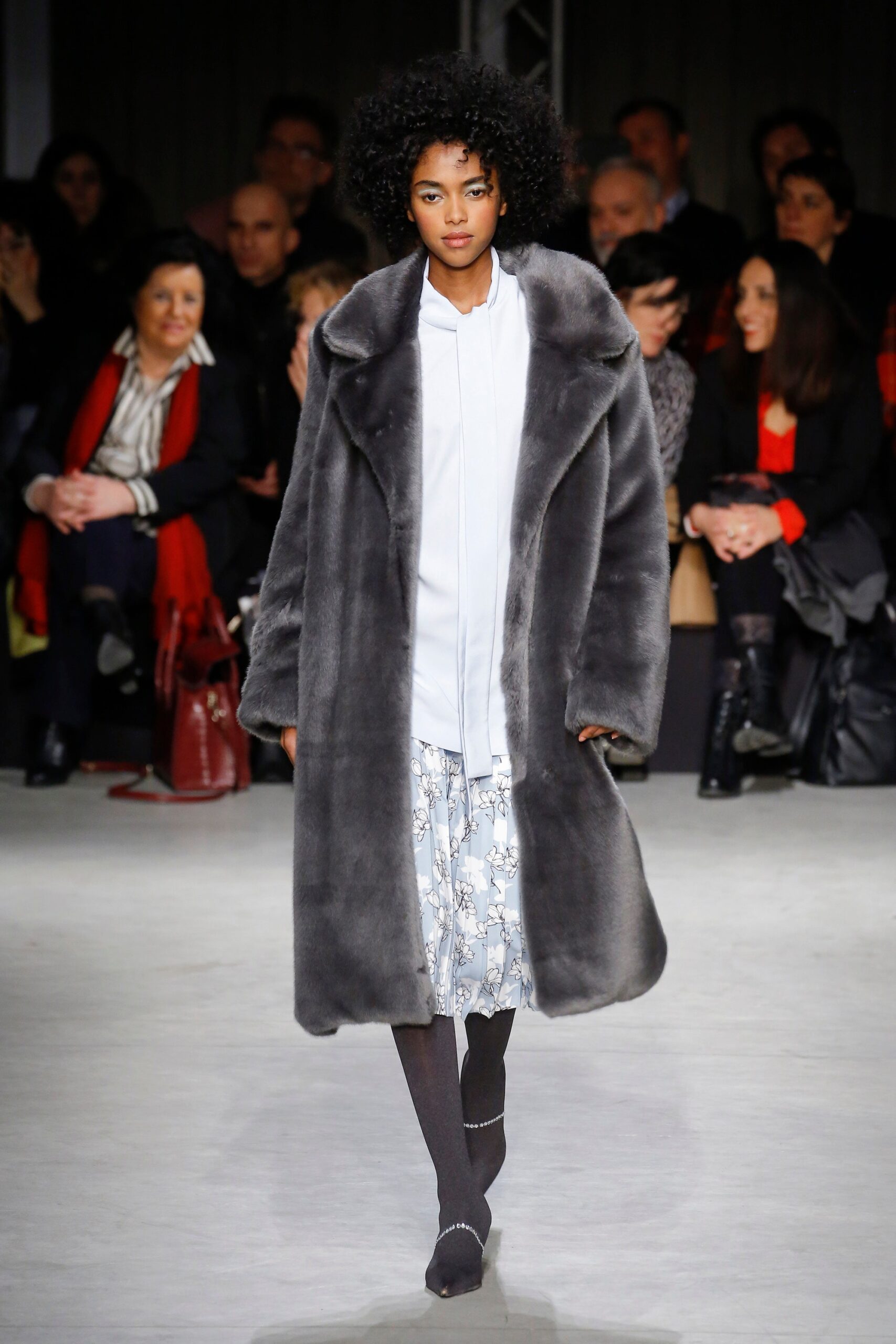 gray faux-fur coat with white blouse and skirt