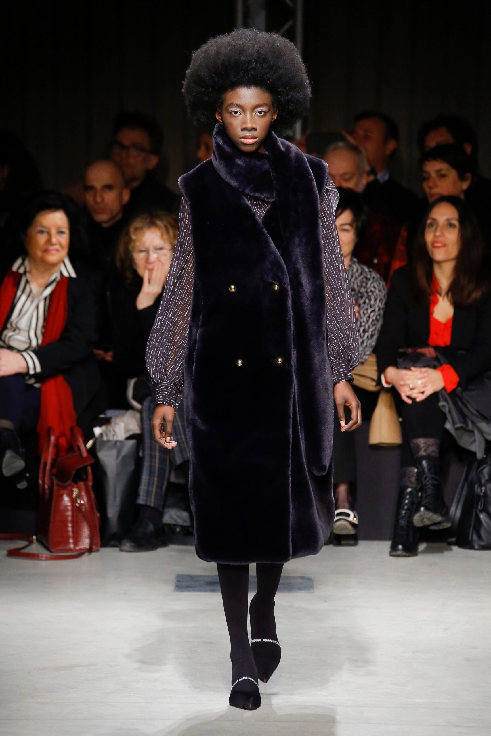 black faux-fur coat with purple blouse