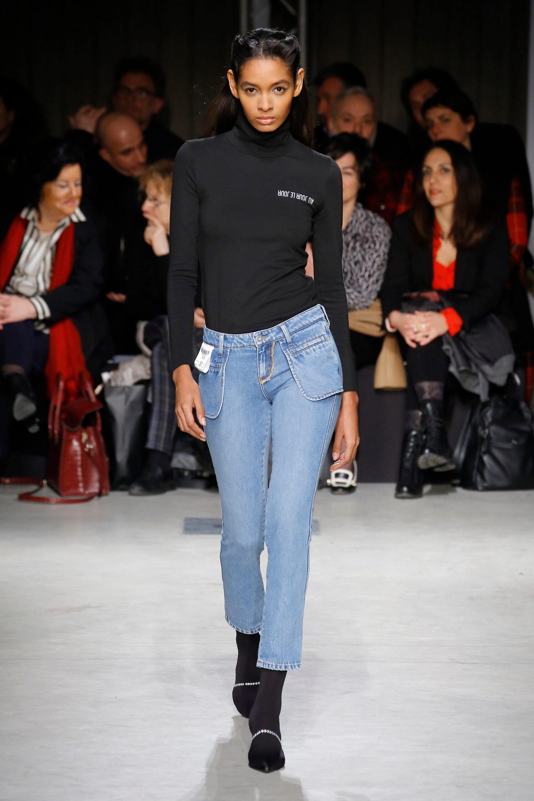 black fitted turtleneck top and blue jeans